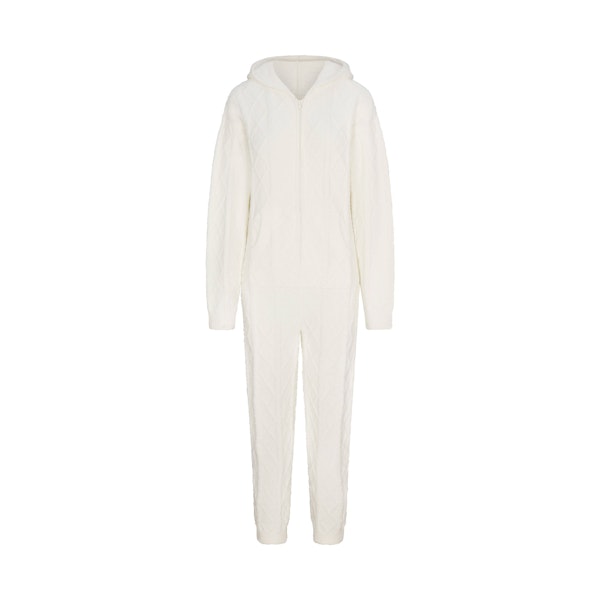 COZY LIGHT OVERSIZED CABLEKNIT ONESIE | IVORY FLAT ON A WHITE BACKGROUND | FLT