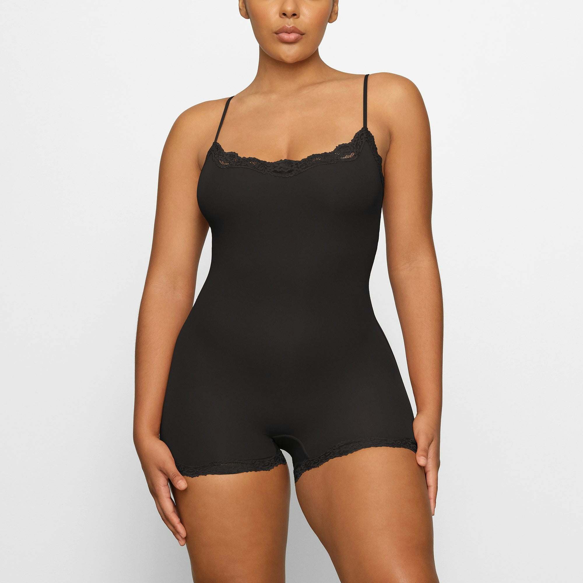 FITS EVERYBODY LACE ONESIE WORN BY A MODEL IN FRONT VIEW