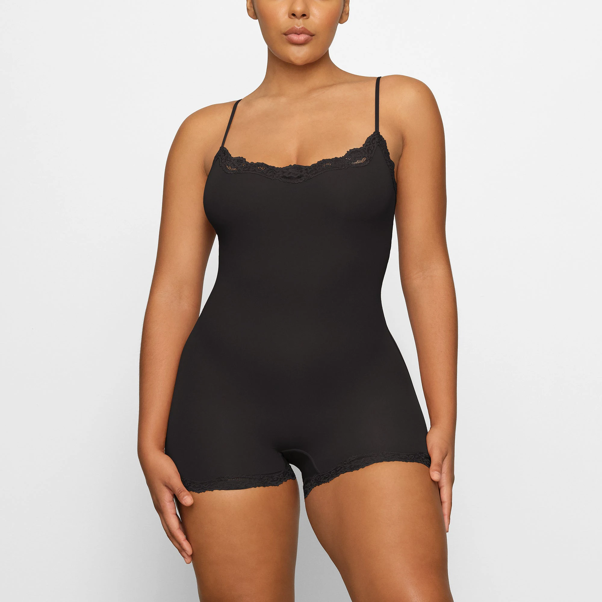 FITS EVERYBODY LACE ONESIE WORN BY A MODEL IN FRONT VIEW