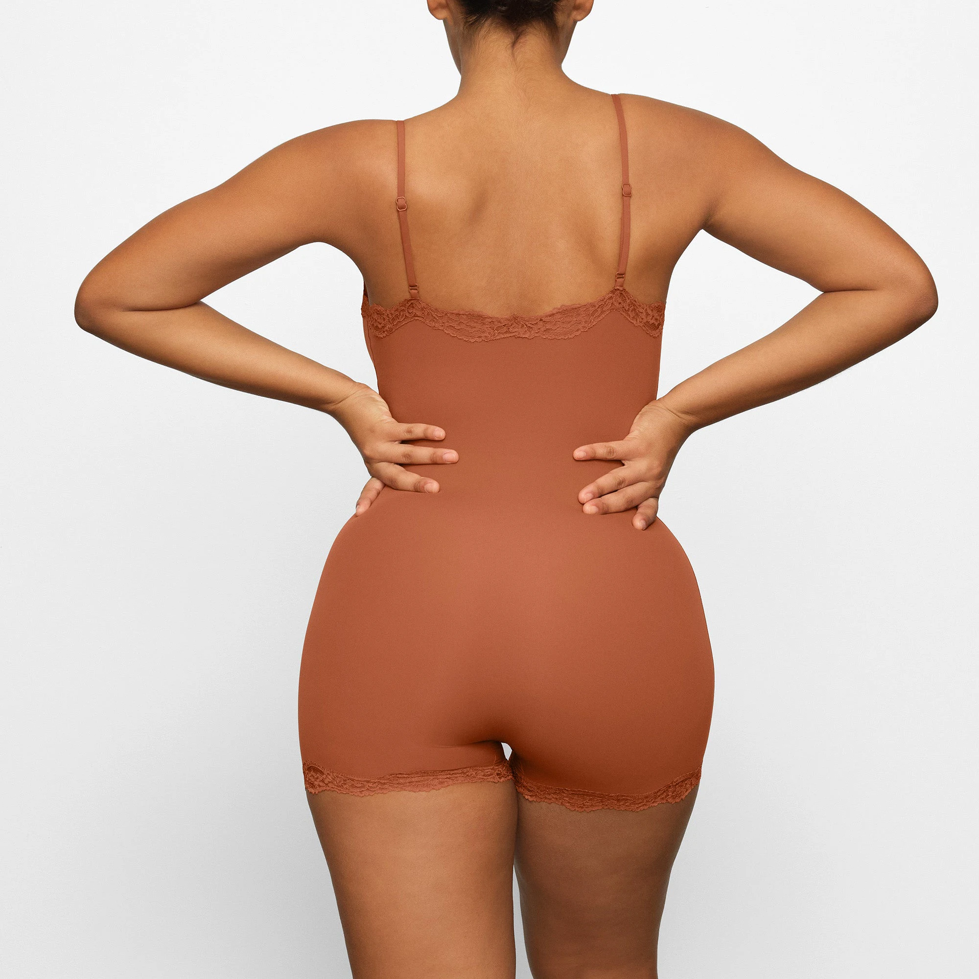 FITS EVERYBODY LACE ONESIE WORN BY A MODEL IN BACK VIEW