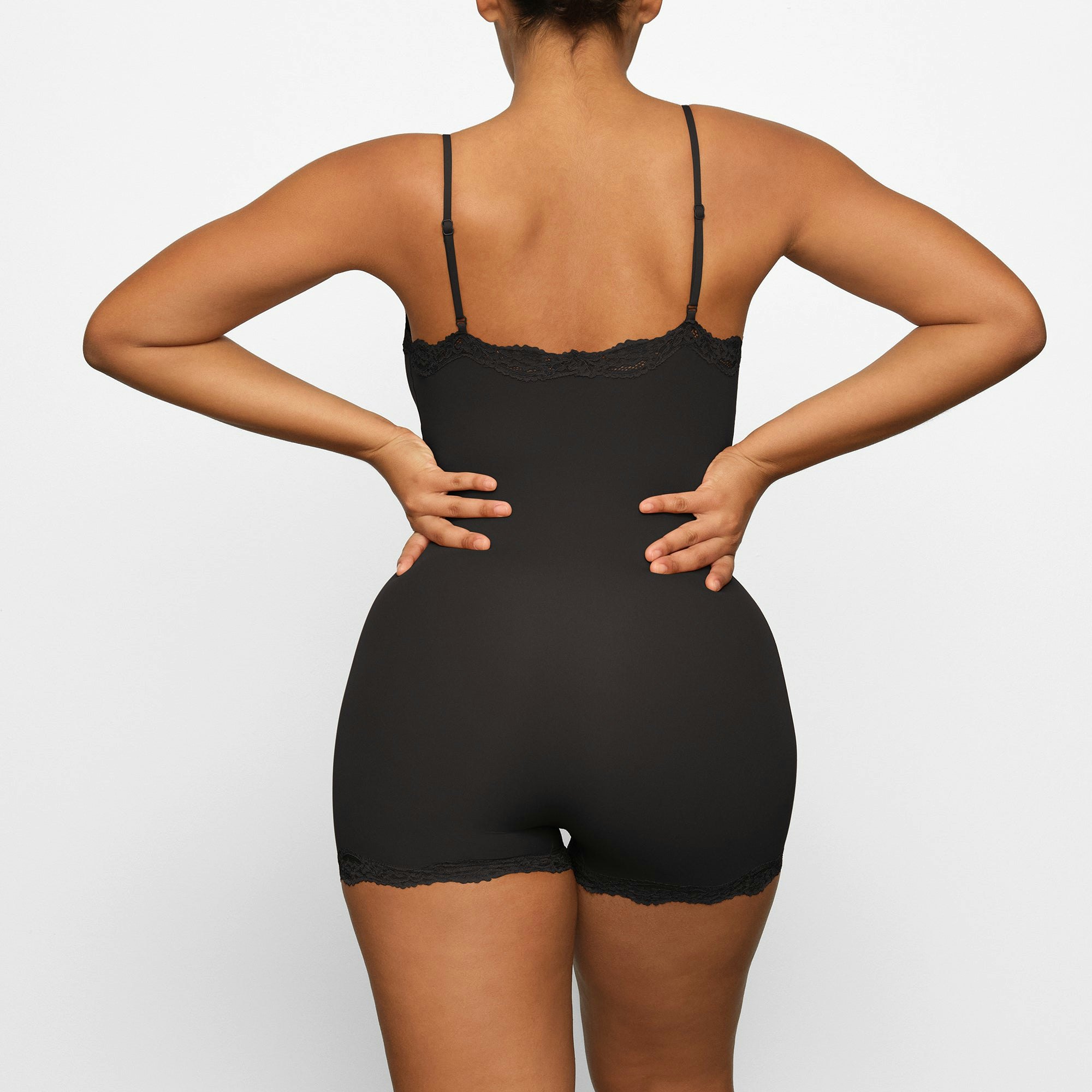 FITS EVERYBODY LACE ONESIE WORN BY A MODEL IN BACK VIEW