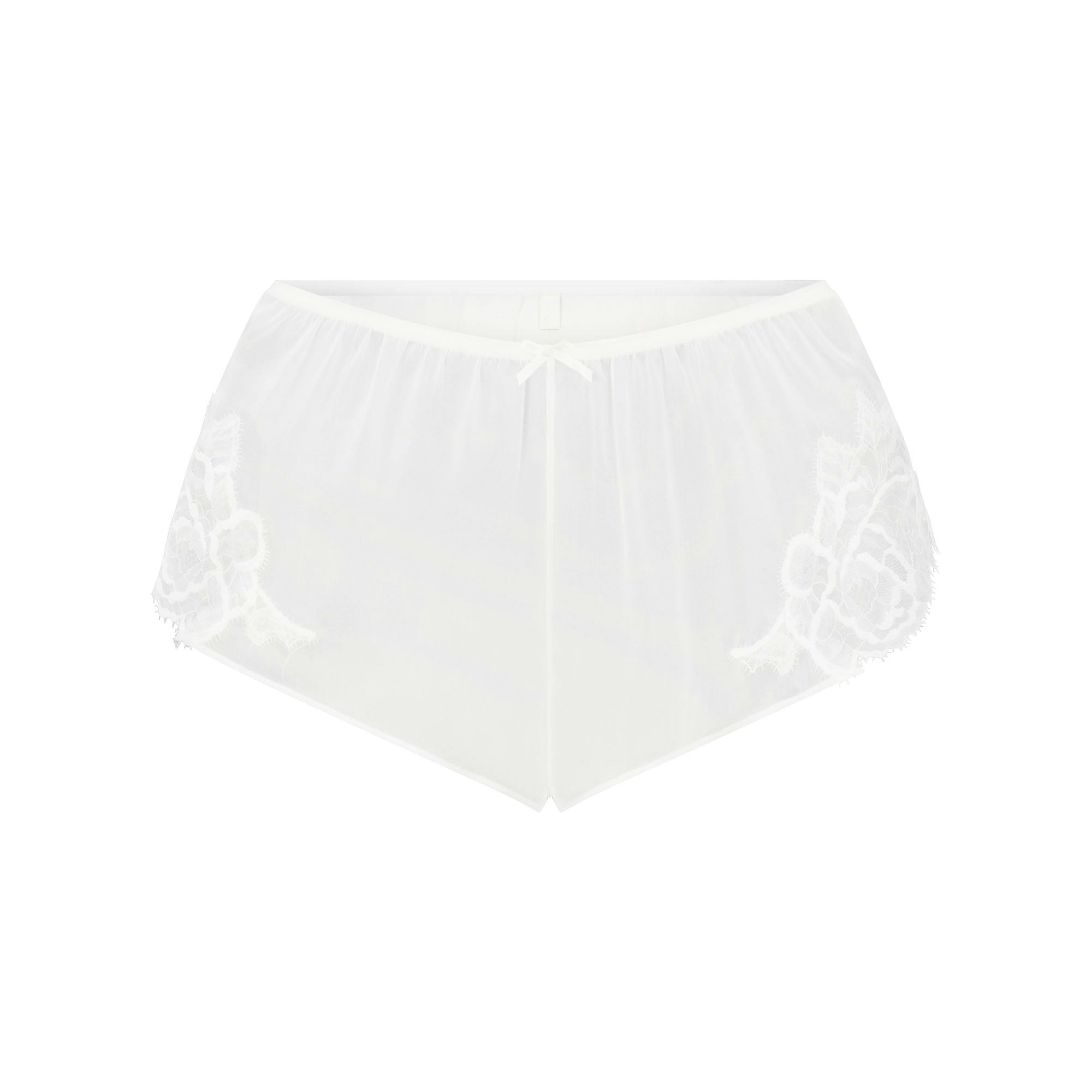 SKIMS ROMANCE CAMI AND SHORT SET | IVORY LAYS FLAT ON A WHITE BACKGROUND | FLT 