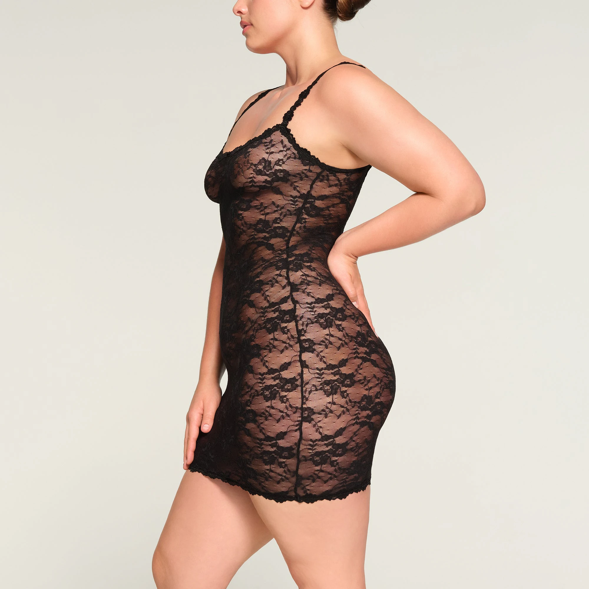 STRETCH LACE SLIP DRESS WORN BY A MODEL IN SIDE VIEW