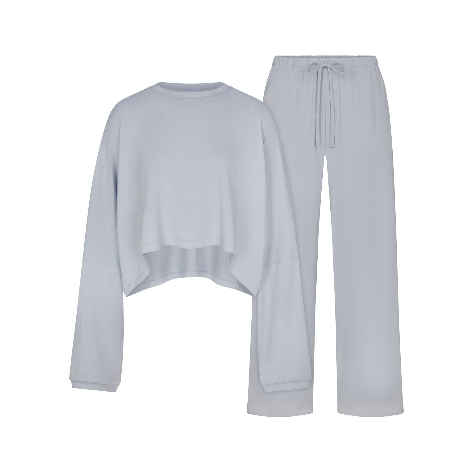 SKIMS SLEEP CROPPED LONG SLEEVE AND PANT SET | ZEN BLUE FLAT ON A WHITE BACKGROUND | FLT
