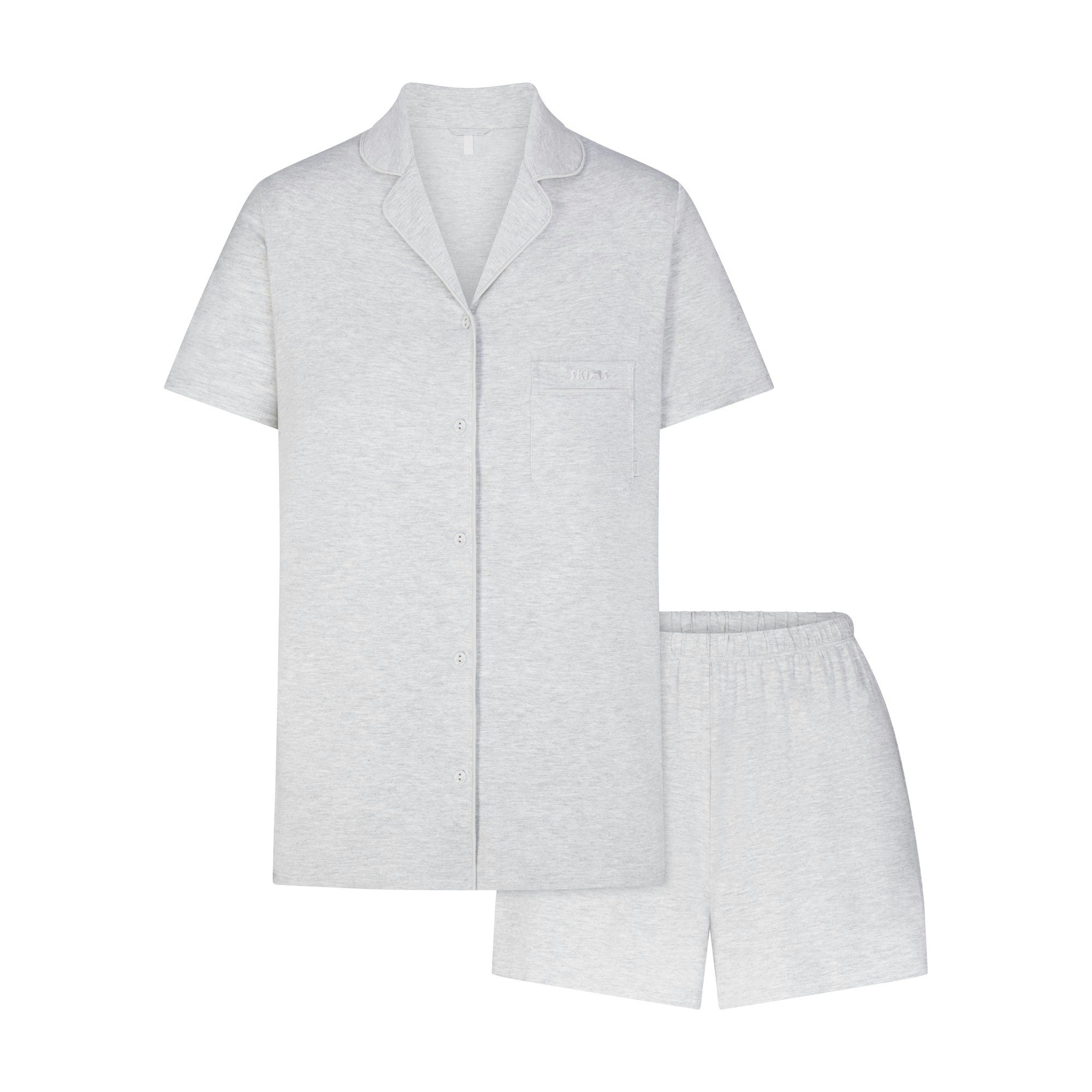 SKIMS SLEEP SHORT SLEEVE BUTTON UP SET | LIGHT HEATHER GREY (SHORTS, BOTTOMS) LAYS FLAT ON A WHITE BACKGROUND | FLT
