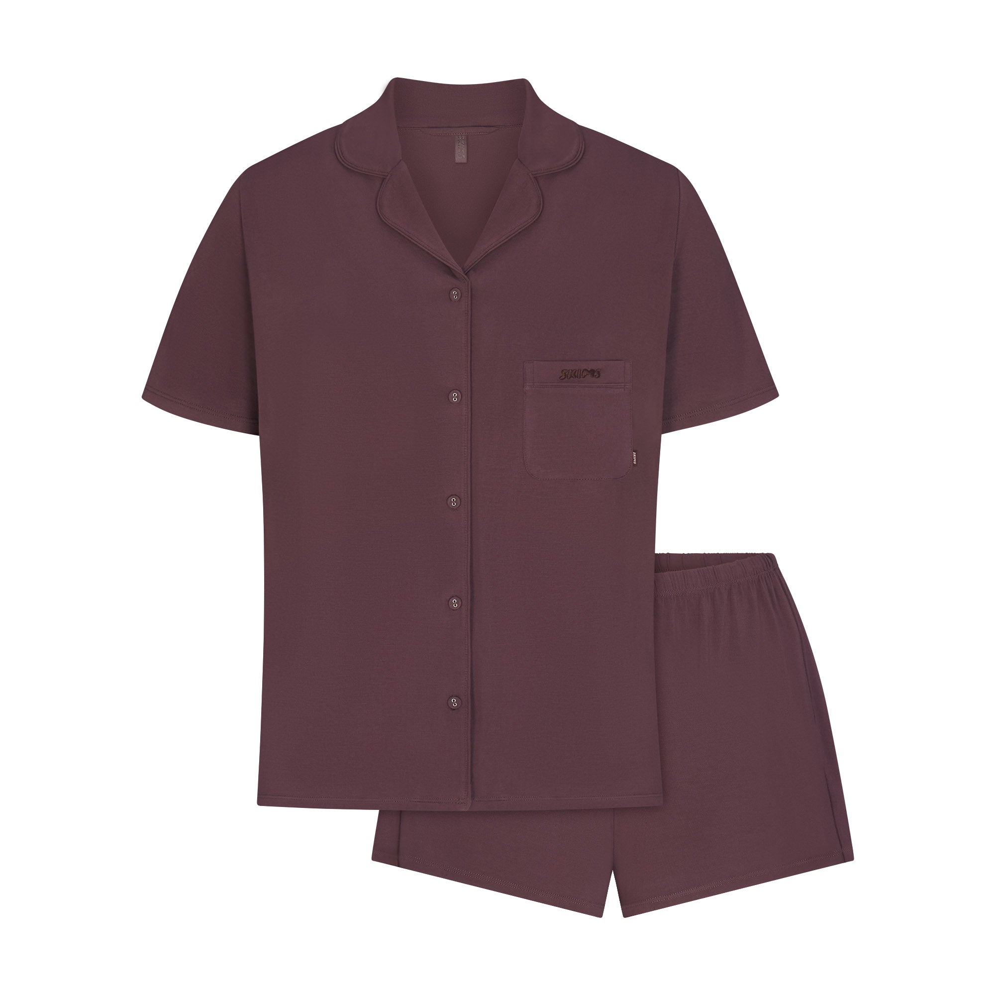 SKIMS SLEEP SHORT SLEEVE BUTTON UP SET | RAISIN FLAT ON A WHITE BACKGROUND | FLT