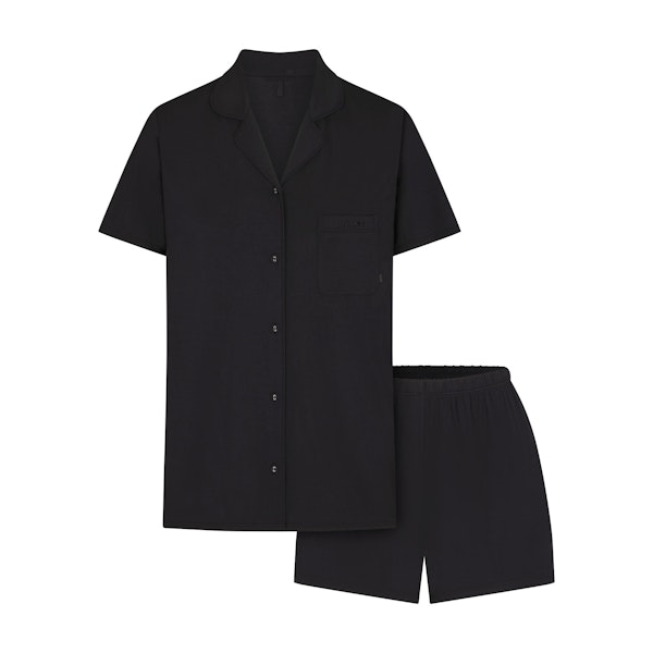 SKIMS SLEEP SHORT SLEEVE BUTTON UP SET | ONYX (SHORTS, BOTTOMS) FLAT ON A WHITE BACKGROUND | FLT