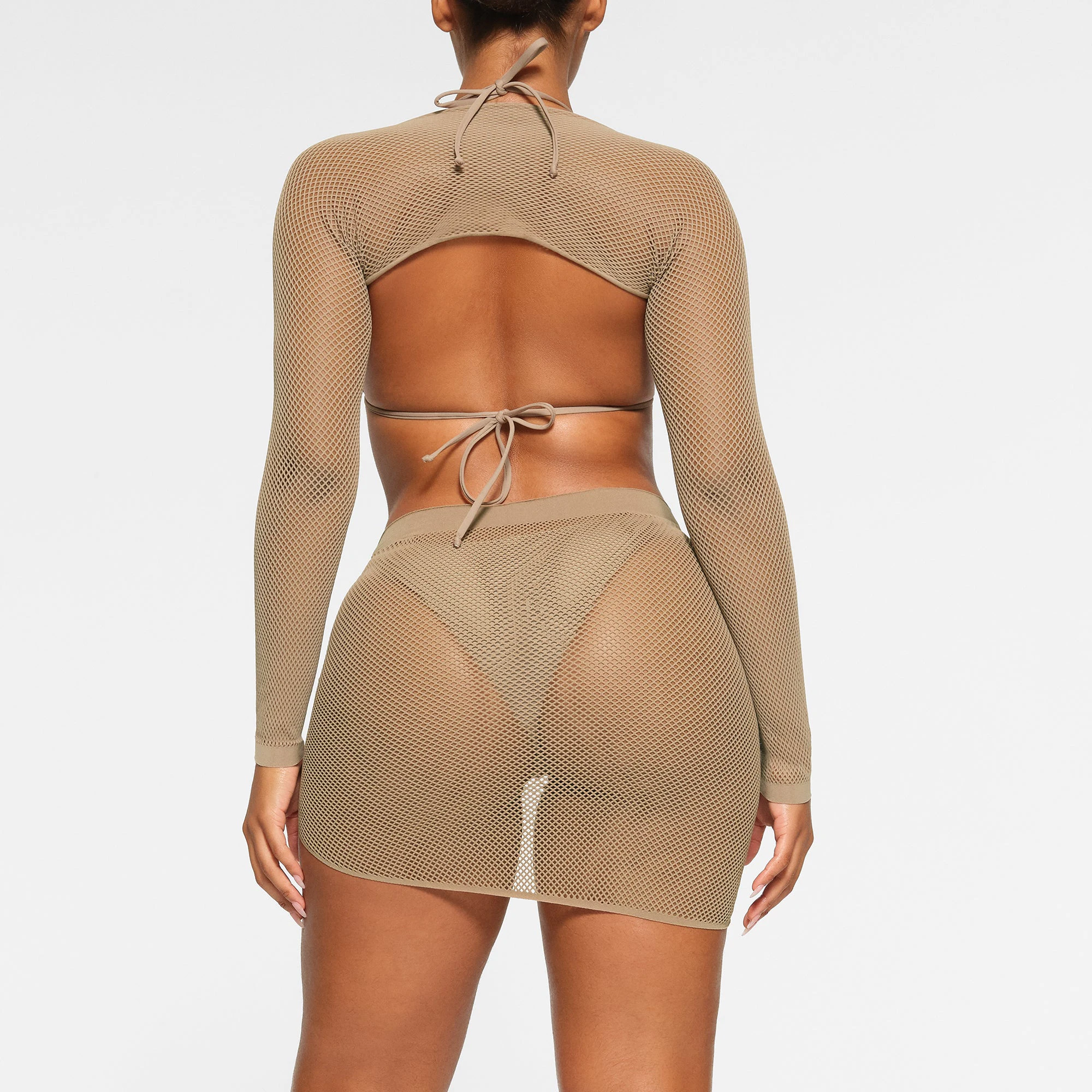 WARP KNIT COVER UP SHRUG WORN BY A MODEL IN BACK VIEW