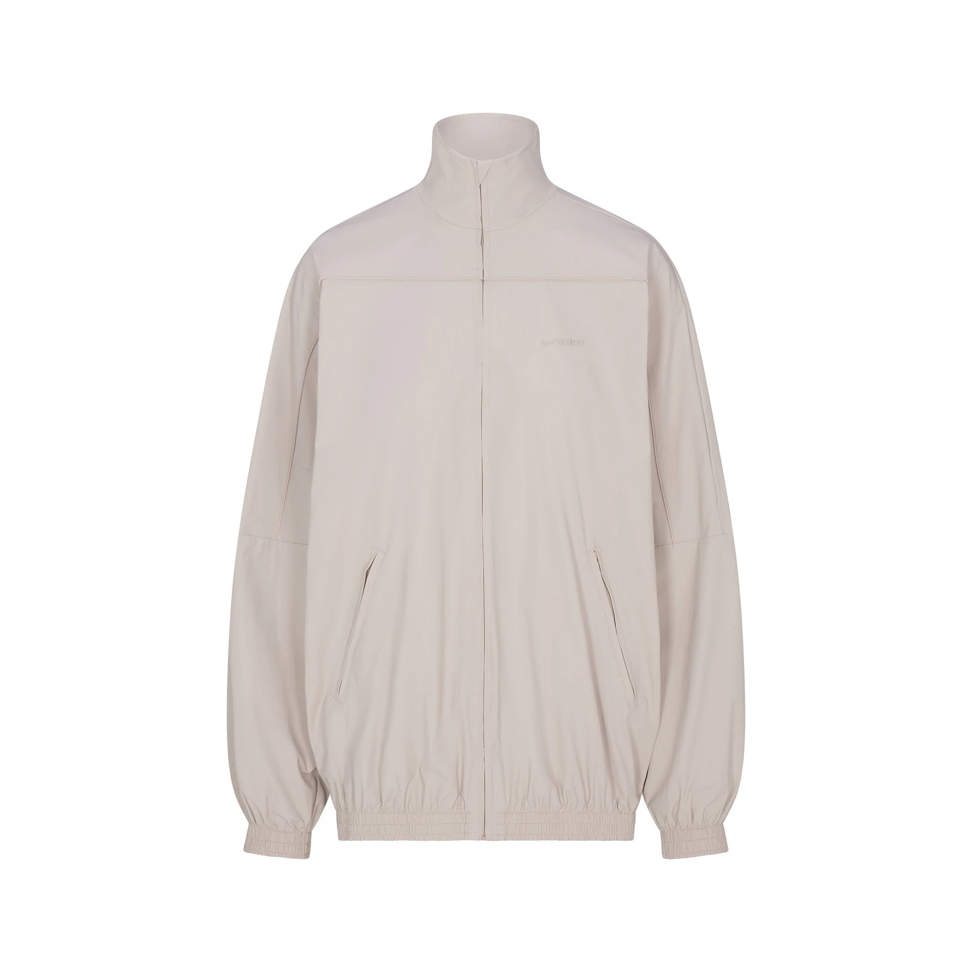 NikeSKIMS WOVEN NYLON OVERSIZED TRACK JACKET | STONE FLAT ON A WHITE BACKGROUND | FLT