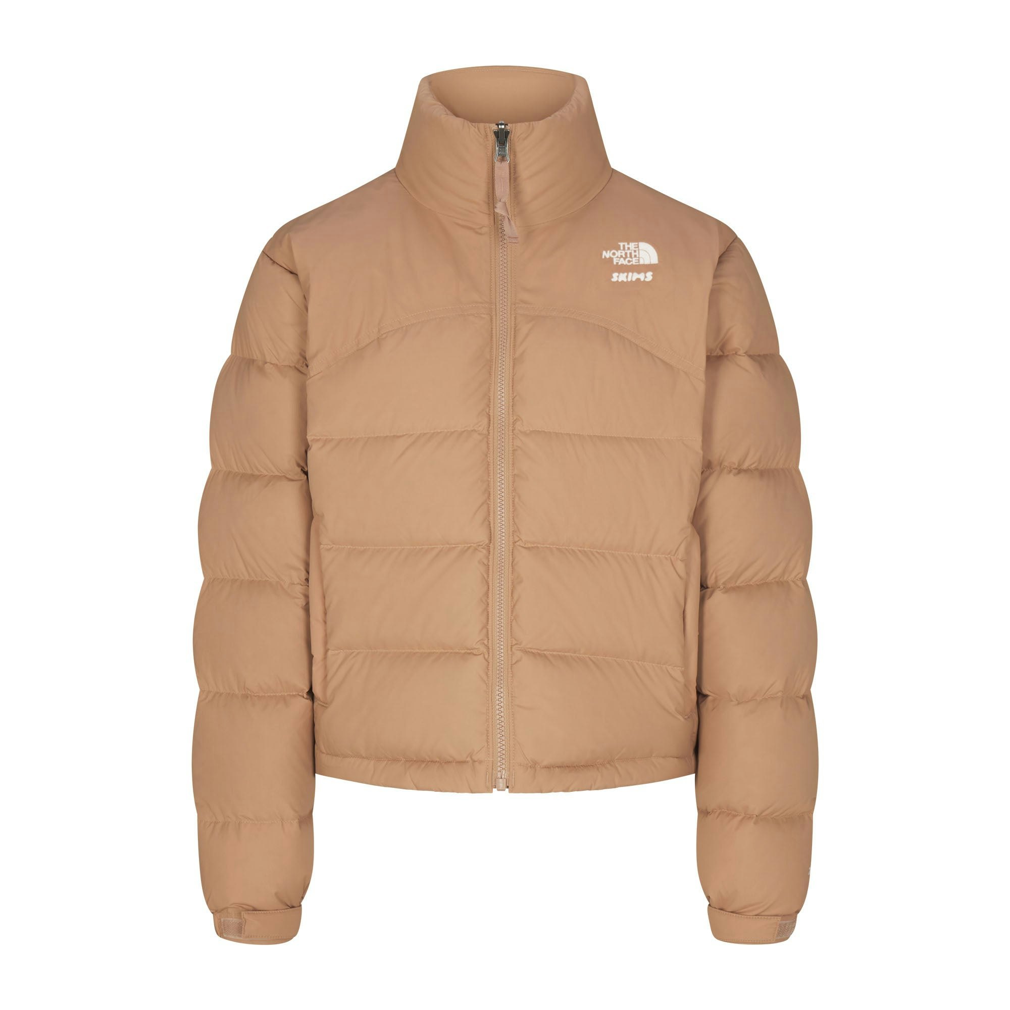 THE NORTH FACE X SKIMS ON A MODEL FRONT VIEW000 RETRO NUPTSE JACKET | OCHRE FLAT ON A WHITE BACKGROUND | FLT