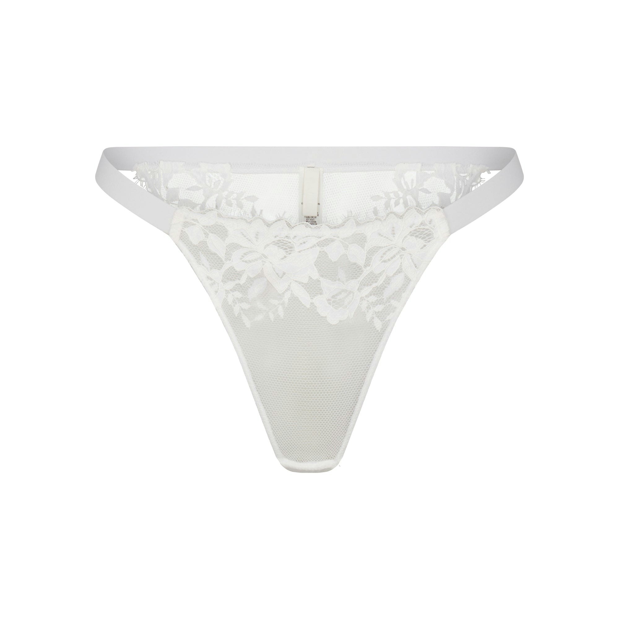 SKIMS LACE BIKINI LAYS FLAT ON A WHITE BACKGROUND