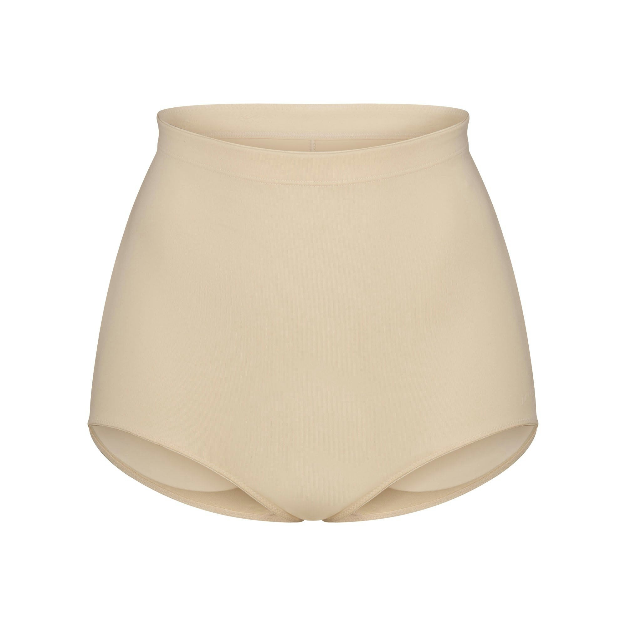 SKIMS BODY BUTT ENHANCING BRIEF | SAND FLAT ON A WHITE BACKGROUND | FLT