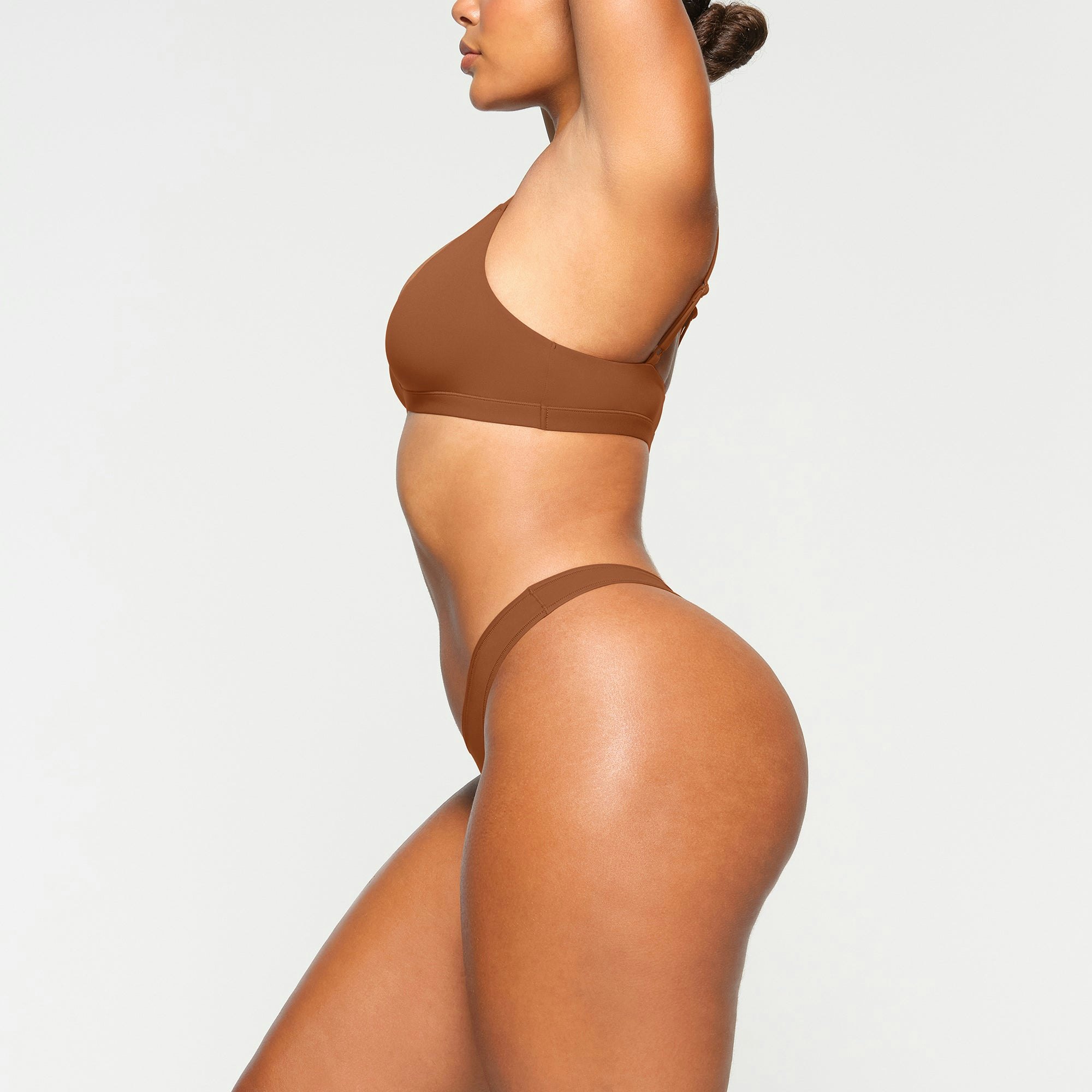 FITS EVERYBODY DIPPED SIDE THONG WORN BY A MODEL IN SIDE VIEW