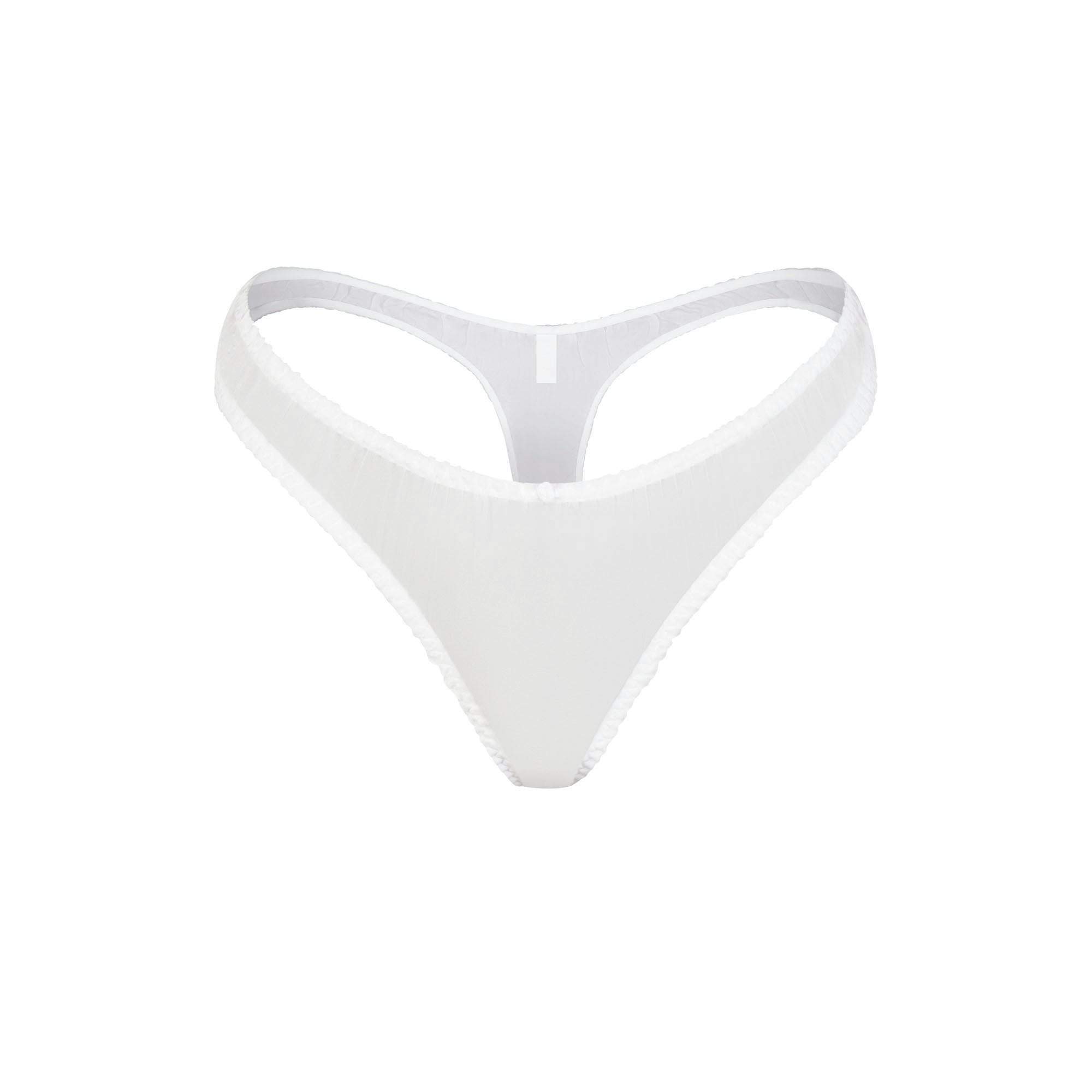 SKIMS ROMANCE DIPPED THONG | SNOW (THONGS, PANTIES) LAYS FLAT ON A WHITE BACKGROUND | FLT
