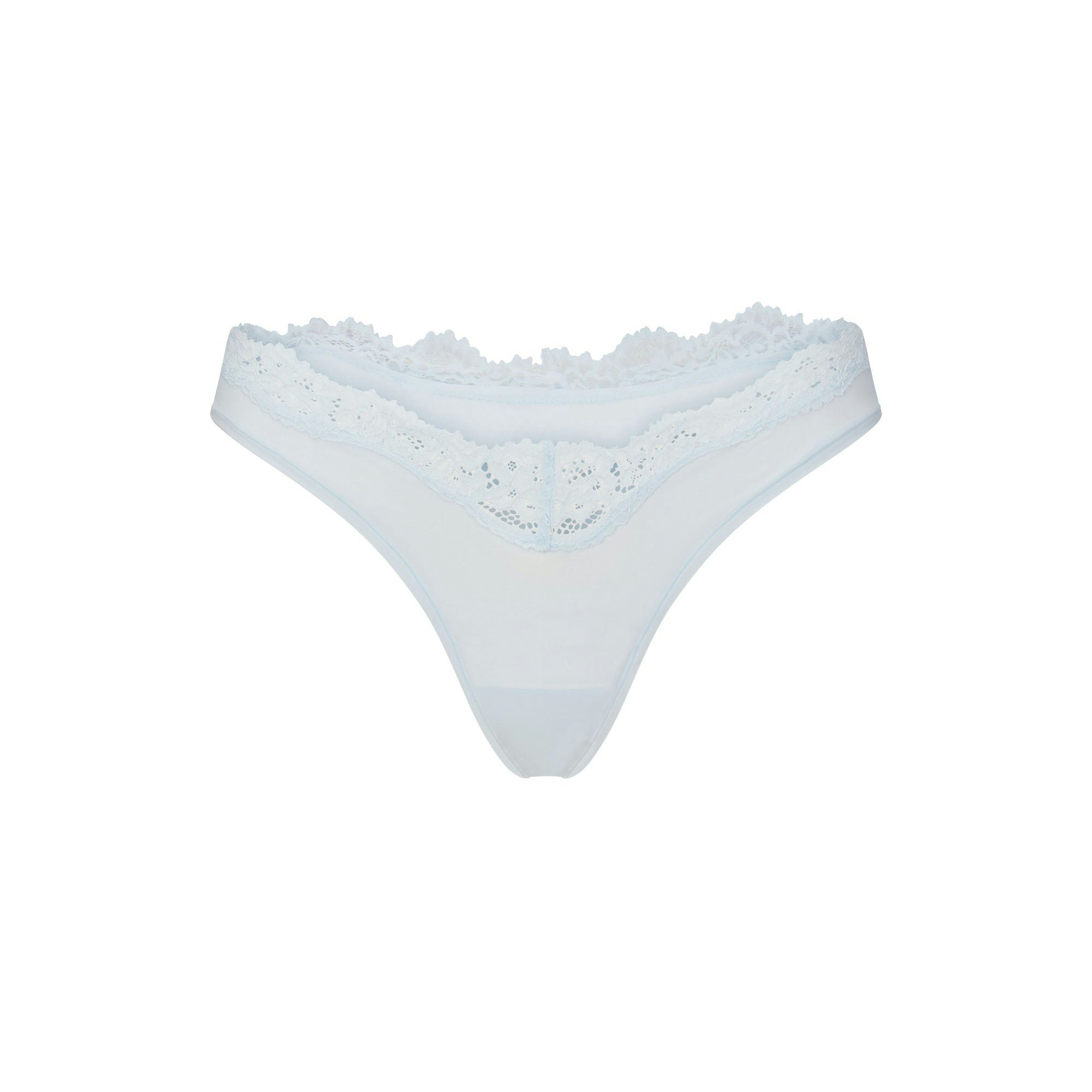 FITS EVERYBODY LACE DIPPED THONG 5-PACK | IVORY PEARL BOW MULTI LAYS FLAT ON A WHITE BACKGROUND