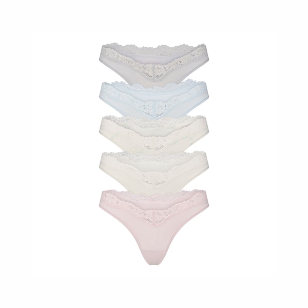 FITS EVERYBODY LACE DIPPED THONG 5-PACK | IVORY PEARL BOW MULTI LAYS FLAT ON A WHITE BACKGROUND | @ | FOCUS: 0.0, 1.0, 0.9 