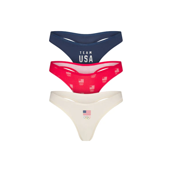 SKIMS FOR TEAM USA COTTON JERSEY OLYMPIC THONG 3-PACK | SKIMS FOR TEAM USA OLYMPIC MULTI FLAT ON A WHITE BACKGROUND | FLT