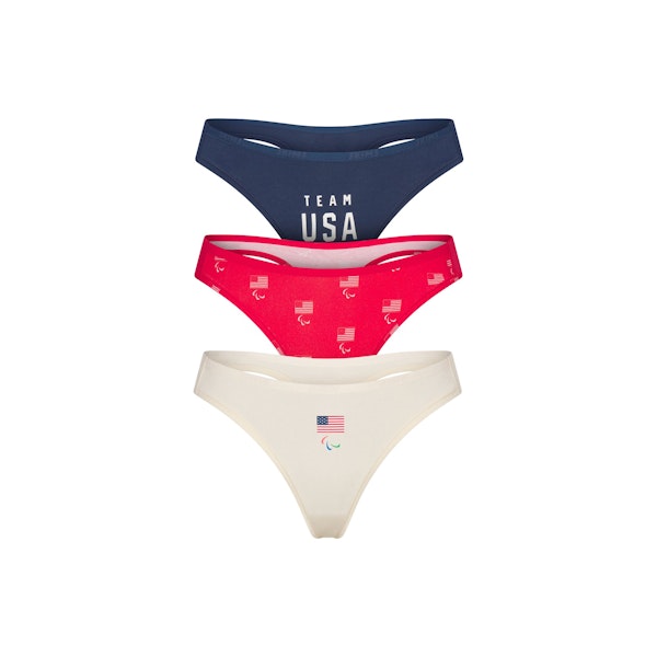 SKIMS FOR TEAM USA COTTON JERSEY PARALYMPIC THONG 3-PACK | SKIMS FOR TEAM USA OLYMPIC MULTI FLAT ON A WHITE BACKGROUND | FLT