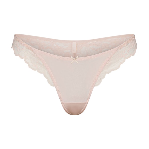 SKIMS LACE THONG | PRIMROSE FLAT ON A WHITE BACKGROUND | FLT