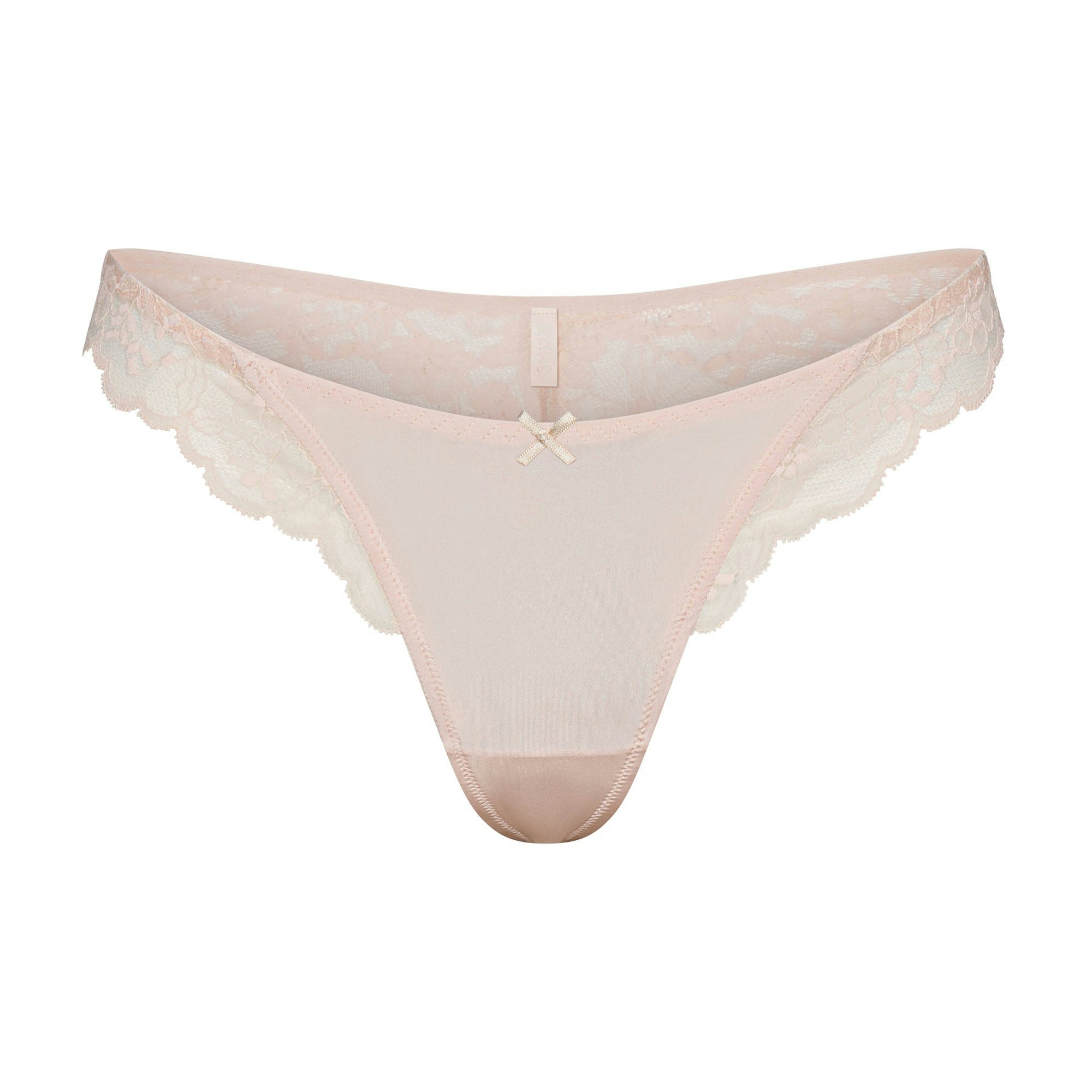 SKIMS LACE THONG | PRIMROSE FLAT ON A WHITE BACKGROUND | FLT