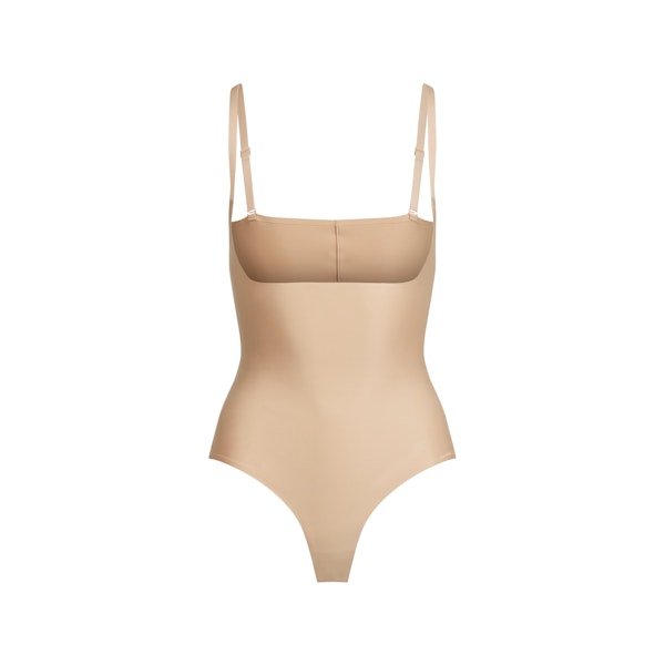 SKIMS BODY CORE SCULPT OPEN BUST THONG BODYSUIT | CLAY FLAT ON A WHITE BACKGROUND | FLT