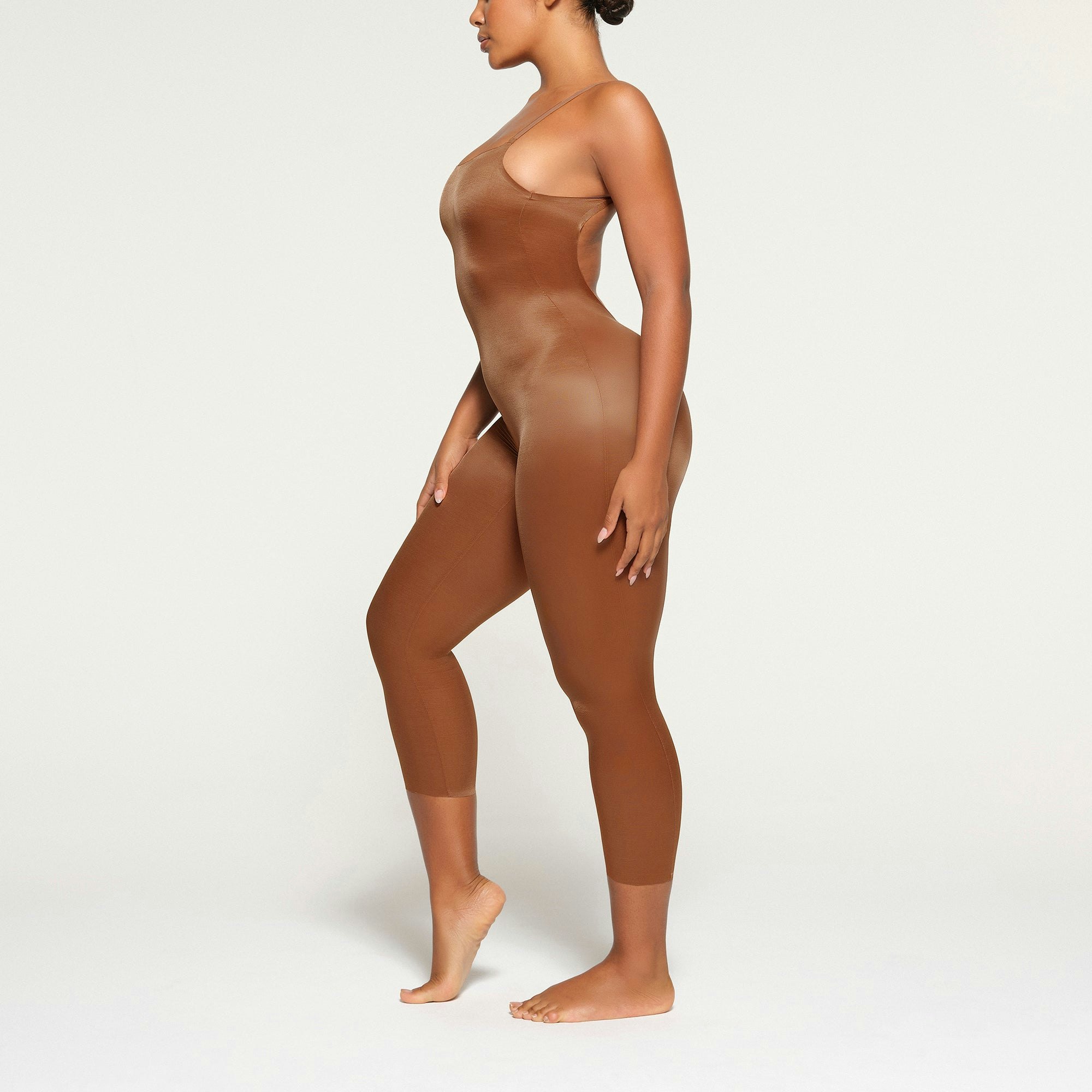 BARELY THERE LOW BACK CATSUIT WORN BY A MODEL IN SIDE VIEW