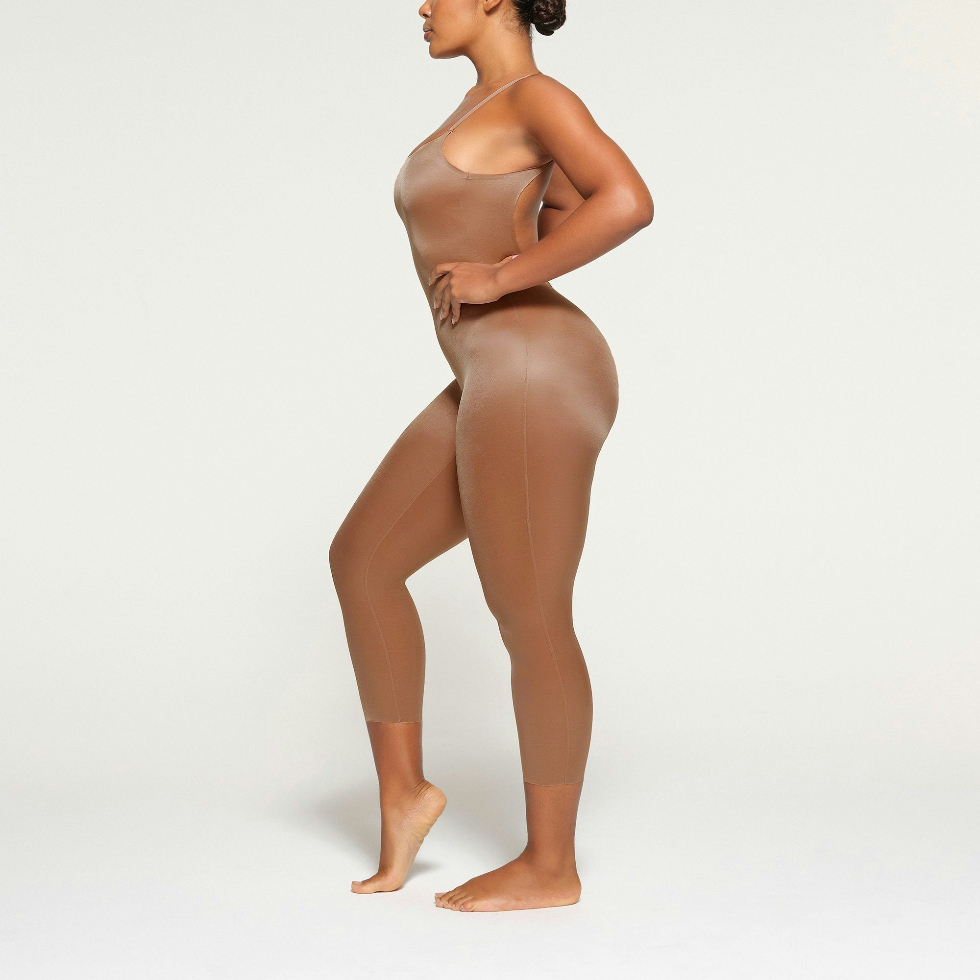 BARELY THERE LOW BACK CATSUIT WORN BY A MODEL IN SIDE VIEW