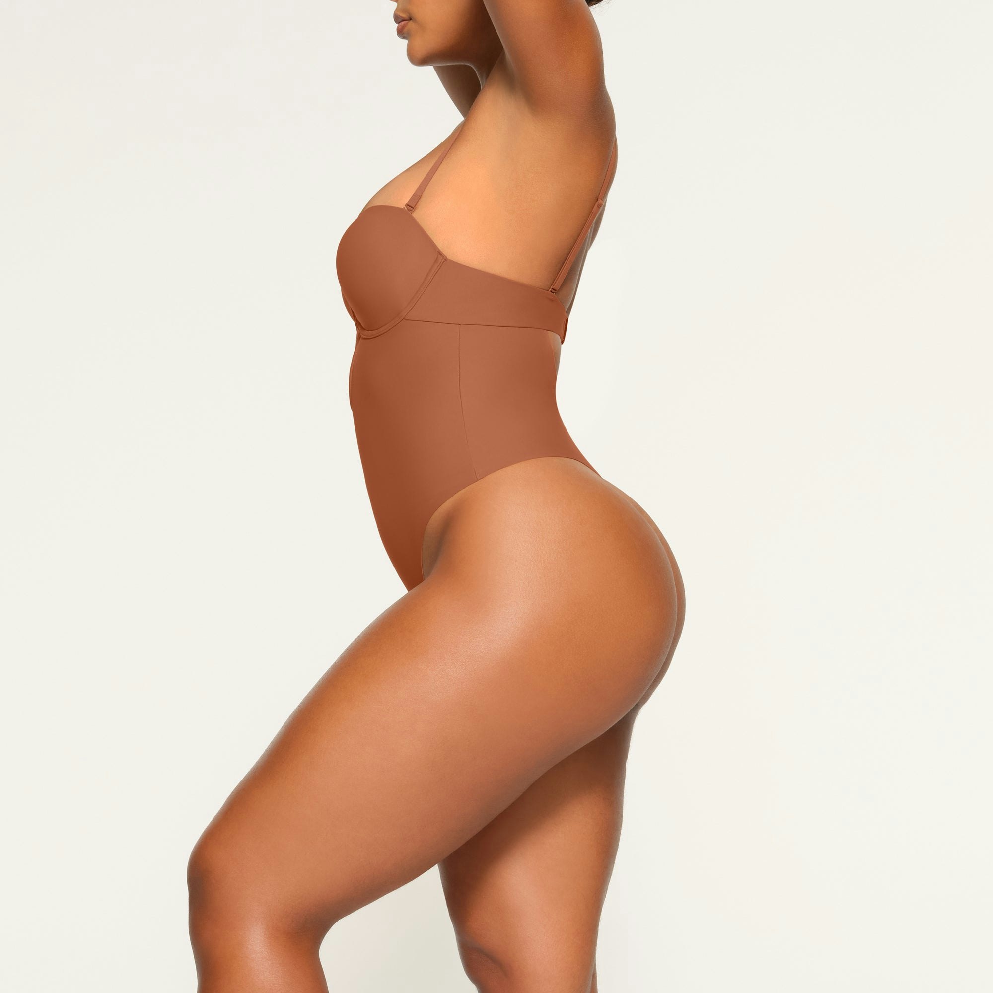 DEEP PLUNGE SHAPEWEAR BODYSUIT WORN BY A MODEL IN SIDE VIEW