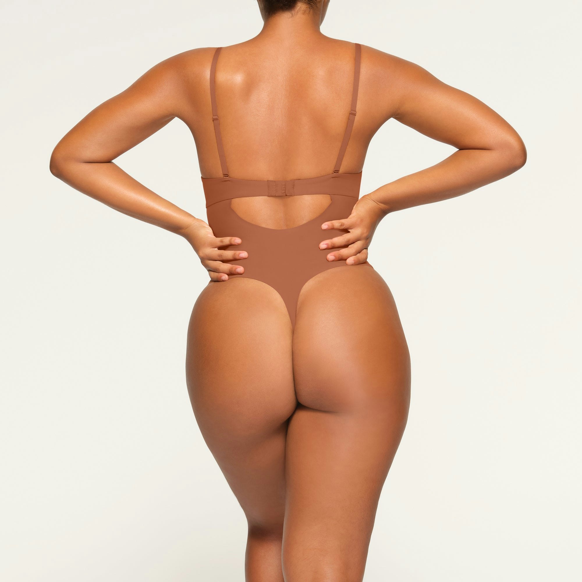 DEEP PLUNGE SHAPEWEAR BODYSUIT WORN BY A MODEL IN BACK VIEW