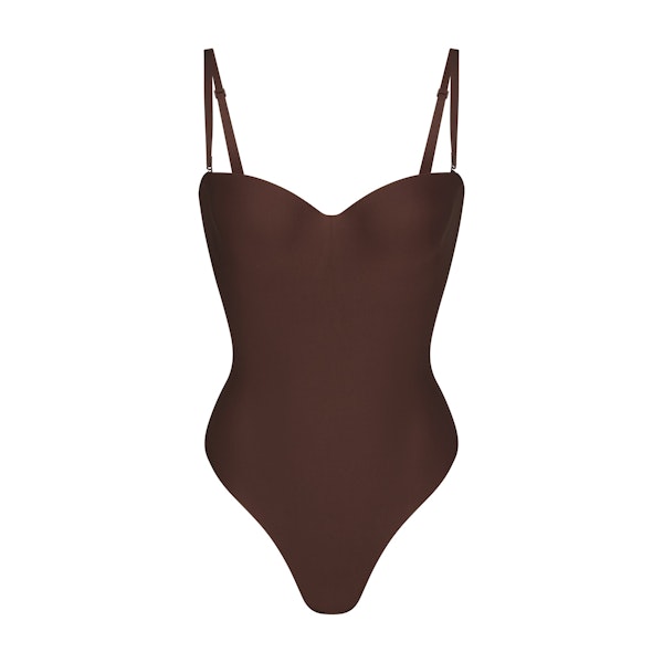 SKIMS BODY UNDERWIRE THONG BODYSUIT | COCOA (SHAPEWEAR BODYSUITS, SHAPEWEAR) LAYS FLAT ON A WHITE BACKGROUND | FLT