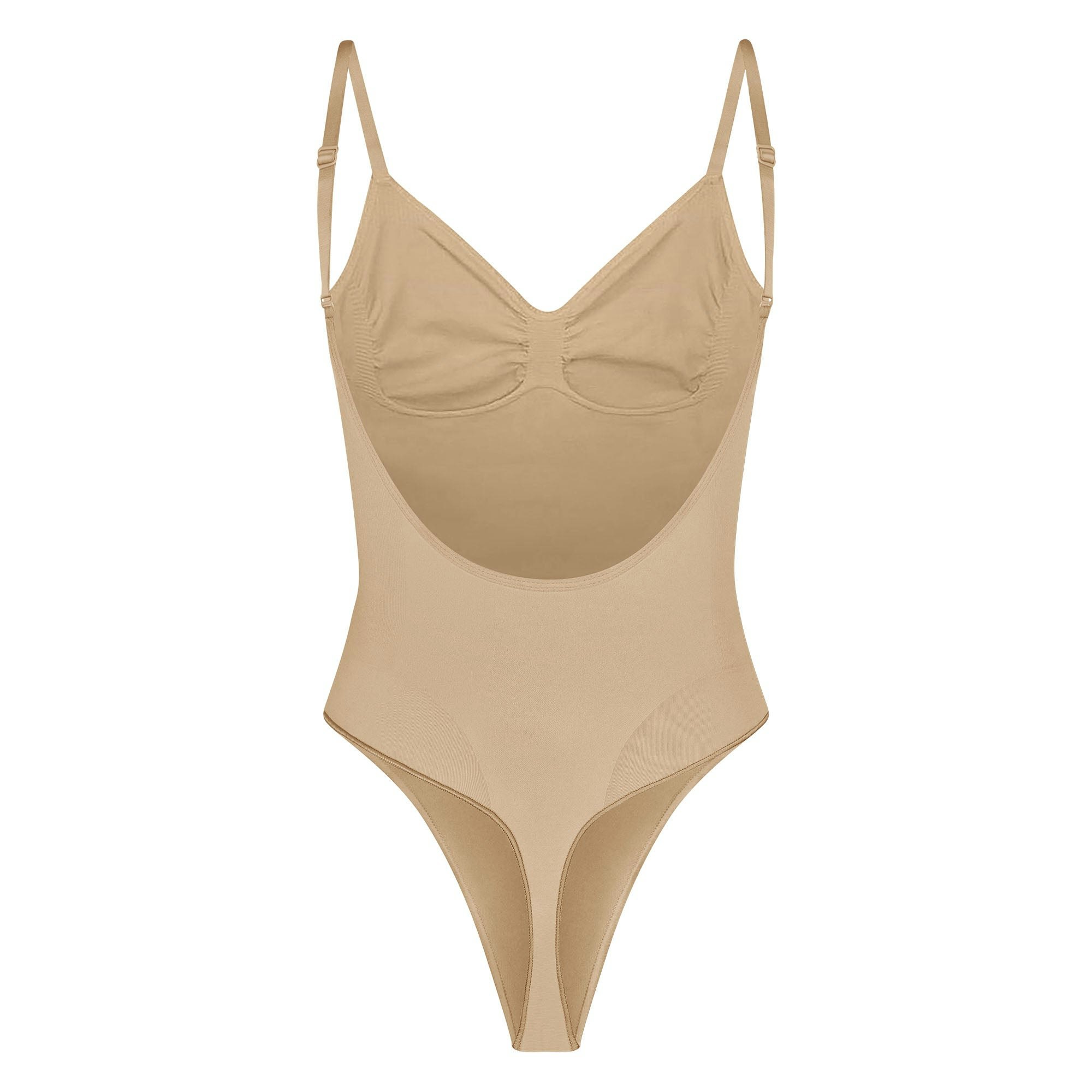 SEAMLESS SCULPT LOW BACK THONG BODYSUIT LAYS FLAT ON A WHITE BACKGROUND | FLT