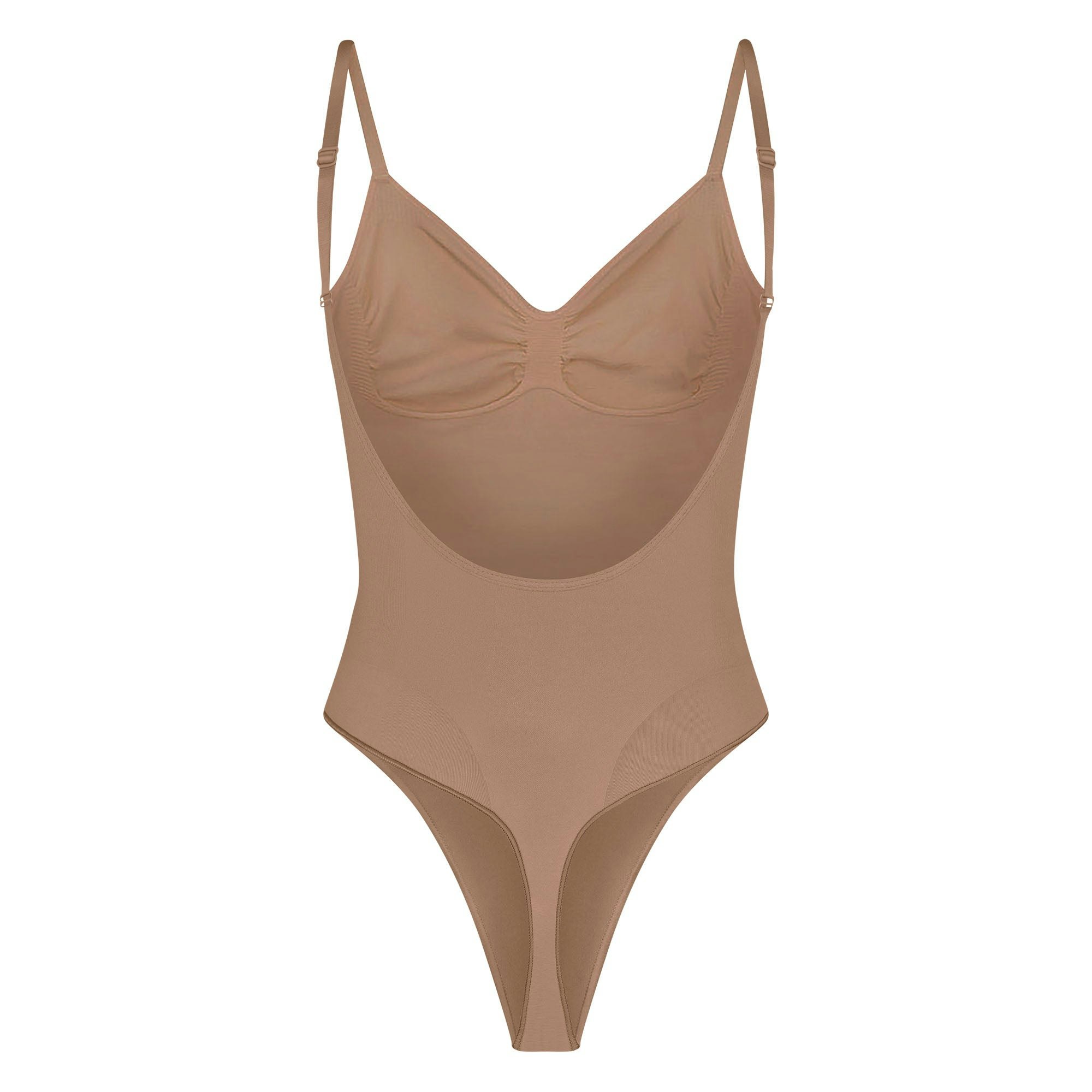 SEAMLESS SCULPT LOW BACK THONG BODYSUIT LAYS FLAT ON A WHITE BACKGROUND | FLT