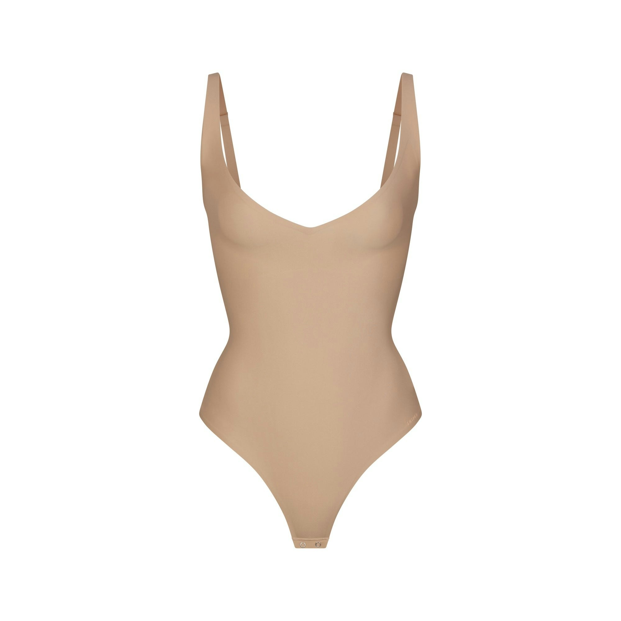 SKIMS BODY CORE SCULPT PLUNGE THONG BODYSUIT | CLAY (SHAPEWEAR BODYSUITS) FLAT ON A WHITE BACKGROUND | FLT