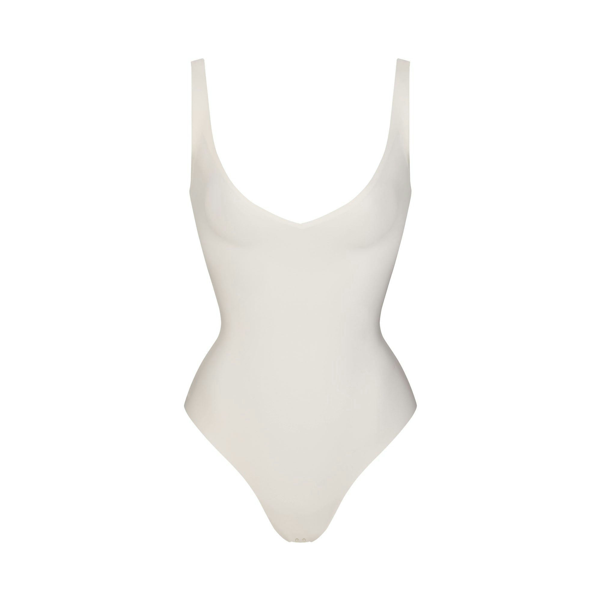SKIMS BODY UNLINED PLUNGE THONG BODYSUIT | IVORY FLAT ON A WHITE BACKGROUND | FLT