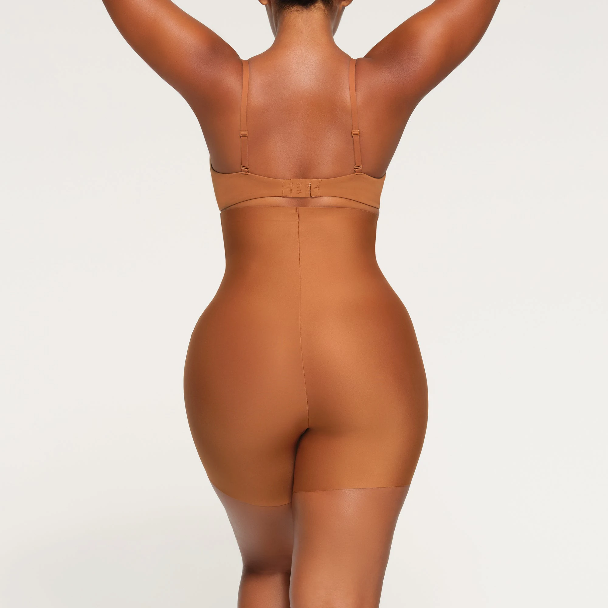 SKIMS BODY HIGH-WAISTED MID THIGH SHORT ON A MODEL BACK VIEW