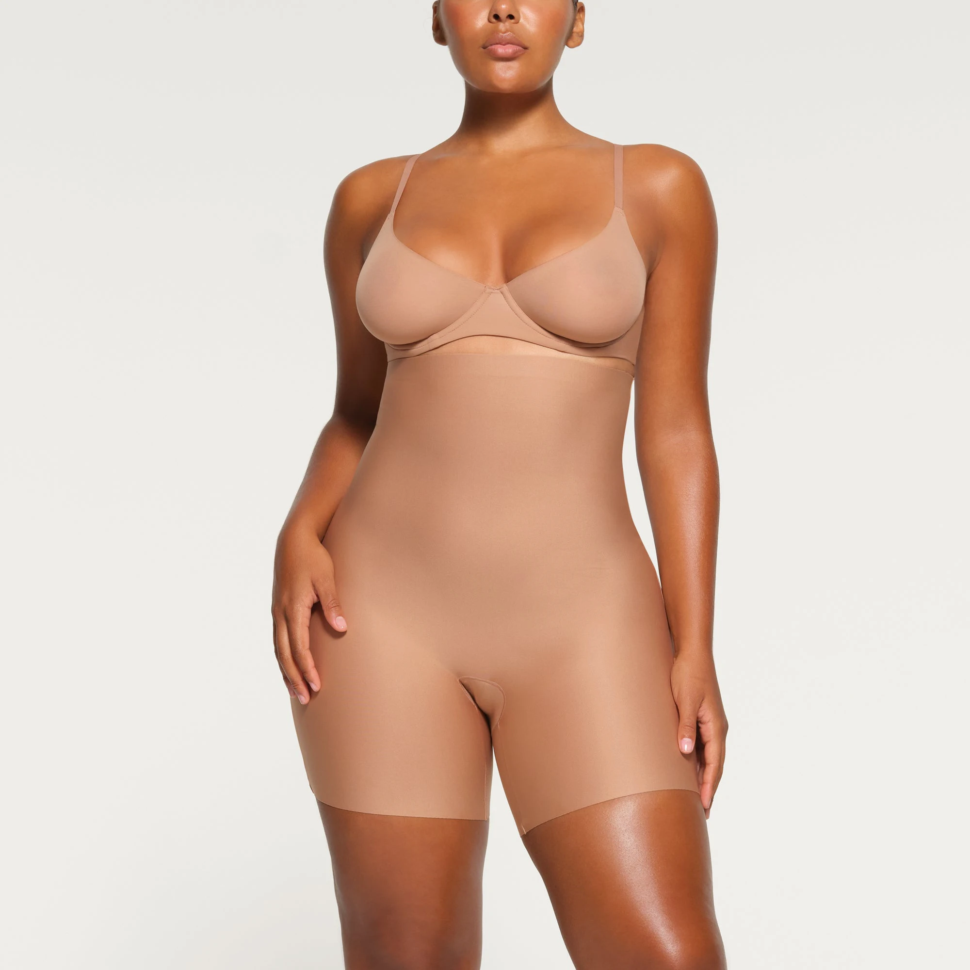 SKIMS BODY HIGH-WAISTED MID THIGH SHORT WORN BY A MODEL IN FRONT VIEW
