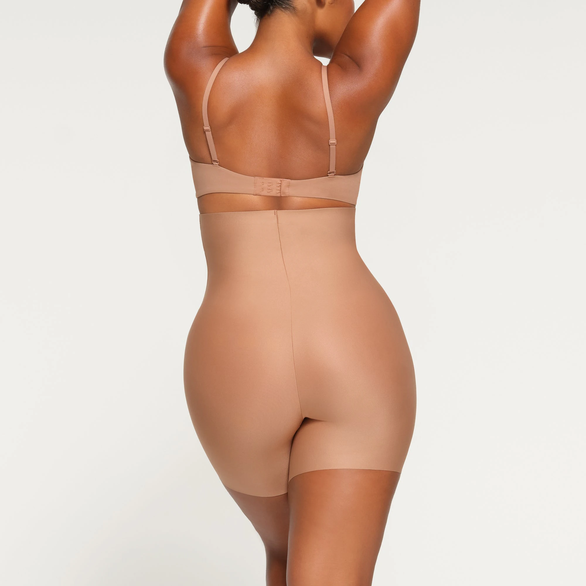 SKIMS BODY HIGH-WAISTED MID THIGH SHORT ON A MODEL BACK VIEW