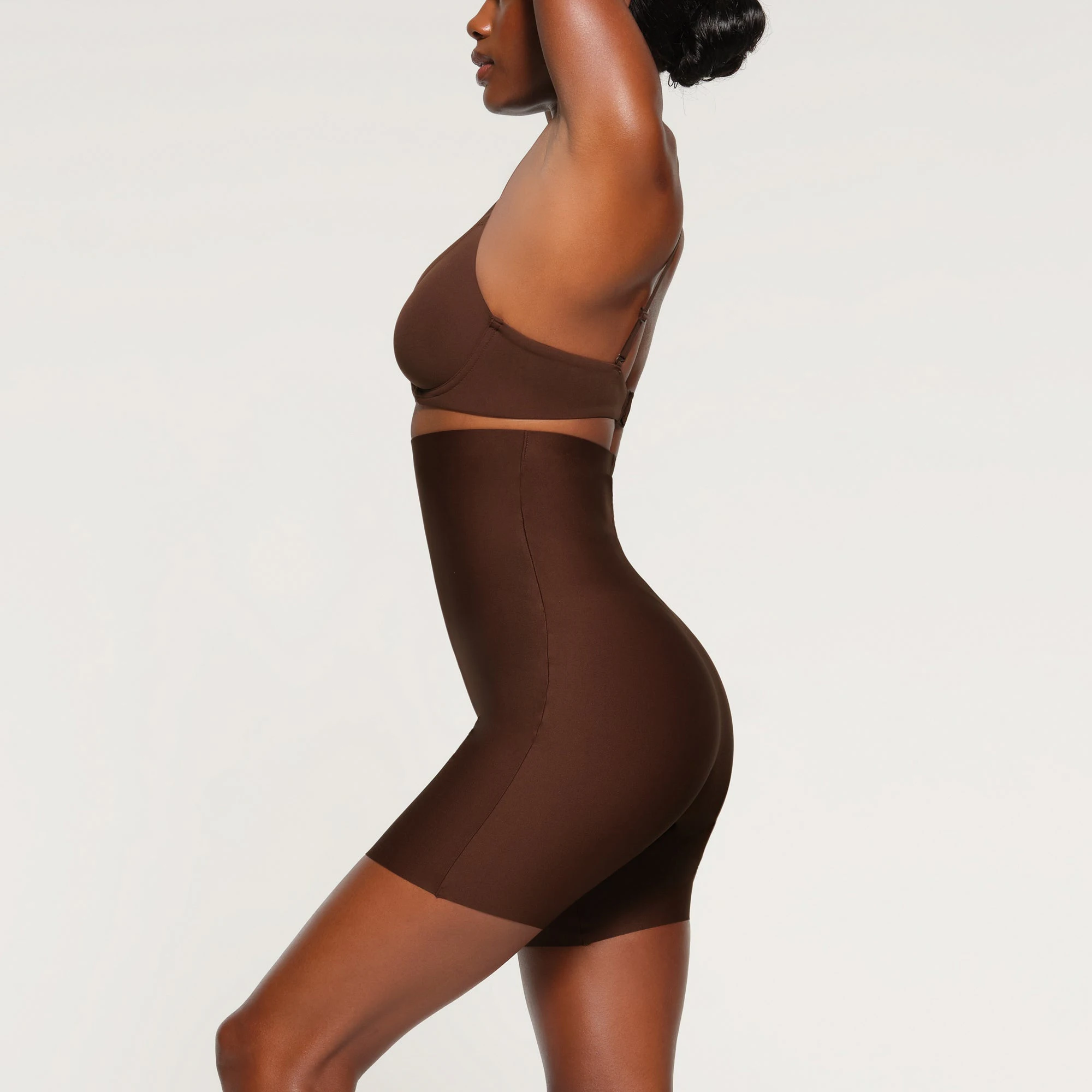SKIMS BODY HIGH-WAISTED MID THIGH SHORT WORN BY A MODEL IN SIDE VIEW