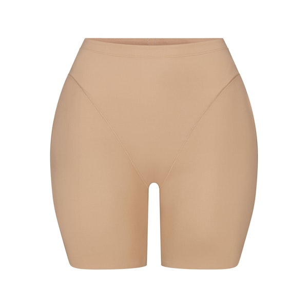 SKIMS BODY BUTT AND HIP ENHANCING MID THIGH SHORT | CLAY FLAT ON A WHITE BACKGROUND | FLT