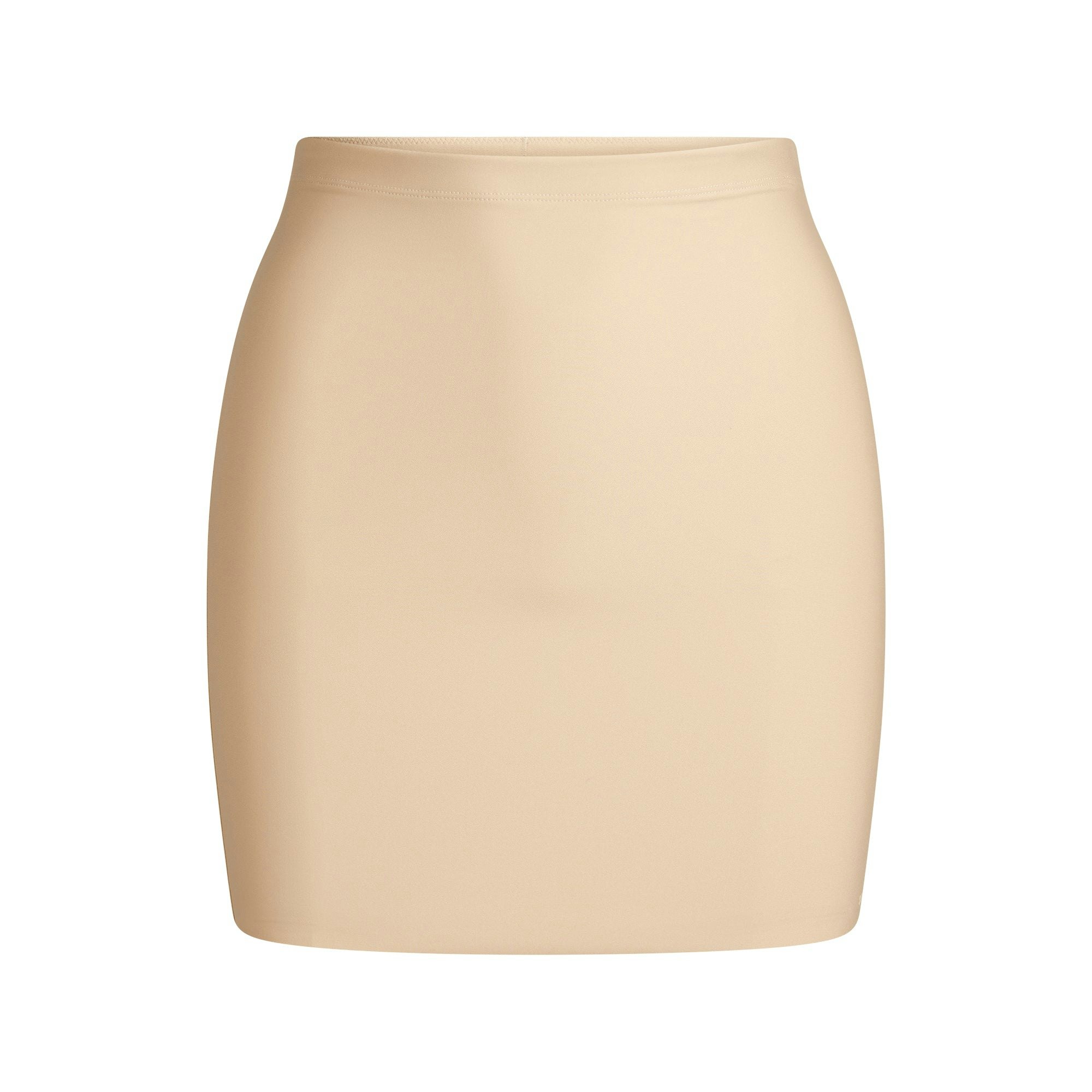 SKIMS BODY CORE SCULPT SKORT | SAND FLAT ON A WHITE BACKGROUND | FLT