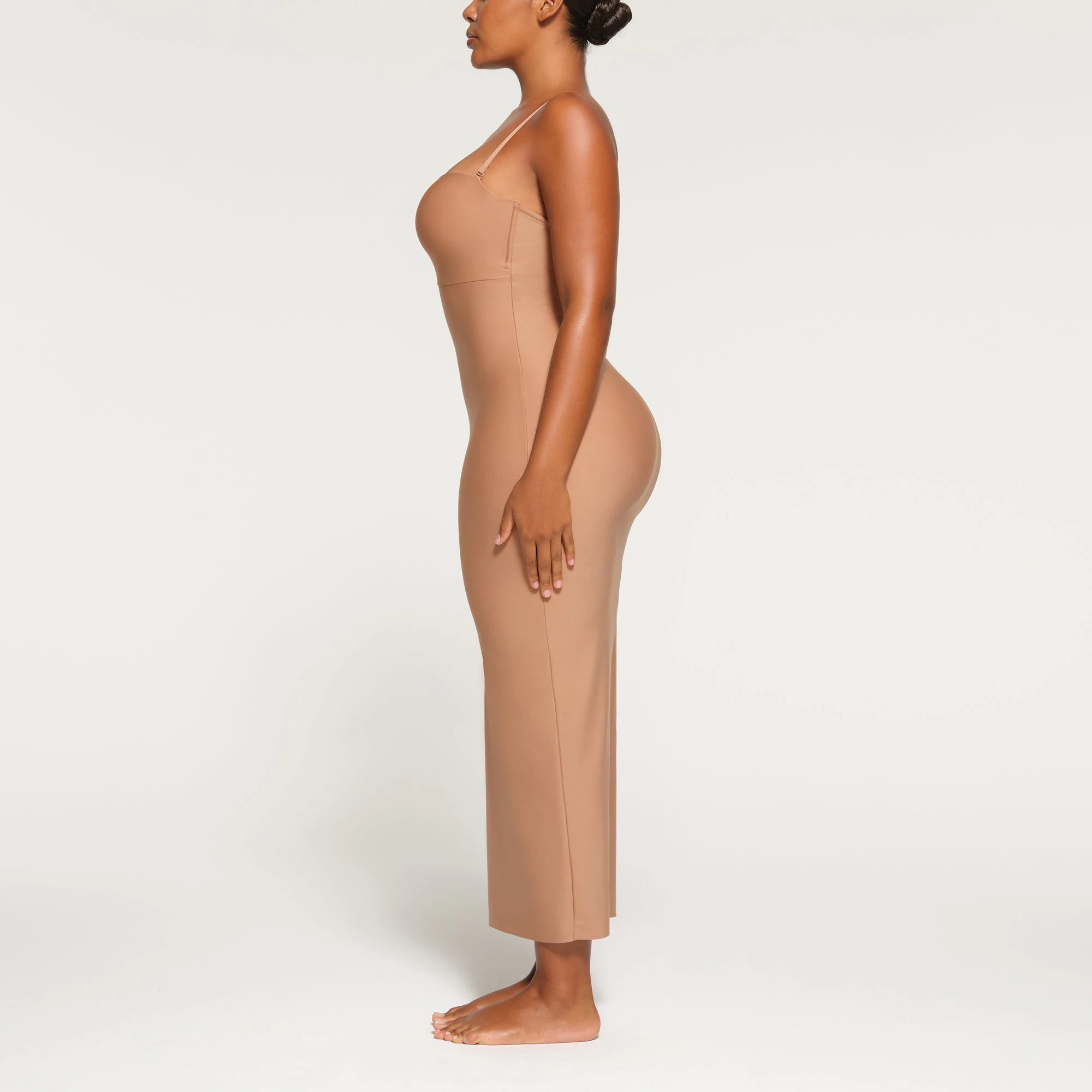 SKIMS BODY UNDERWIRE LONG DRESS WORN BY A MODEL IN SIDE VIEW
