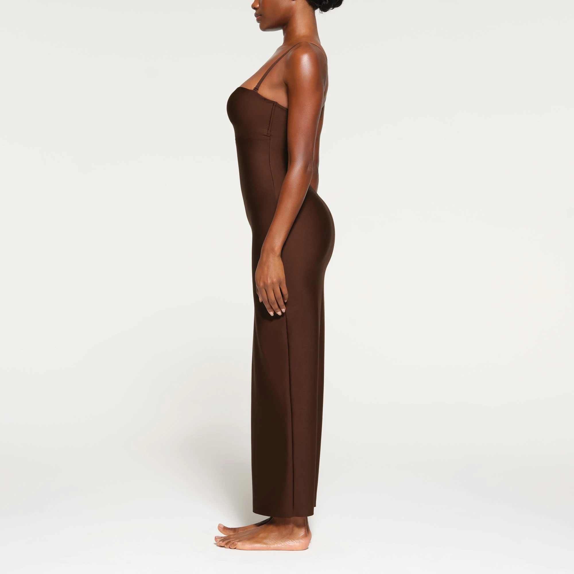 SKIMS BODY UNDERWIRE LONG DRESS WORN BY A MODEL IN SIDE VIEW