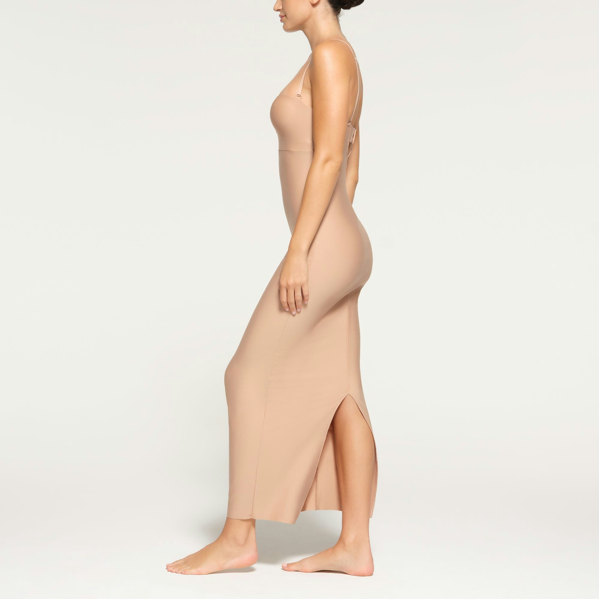 SKIMS BODY UNDERWIRE LONG DRESS WORN BY A MODEL IN SIDE VIEW