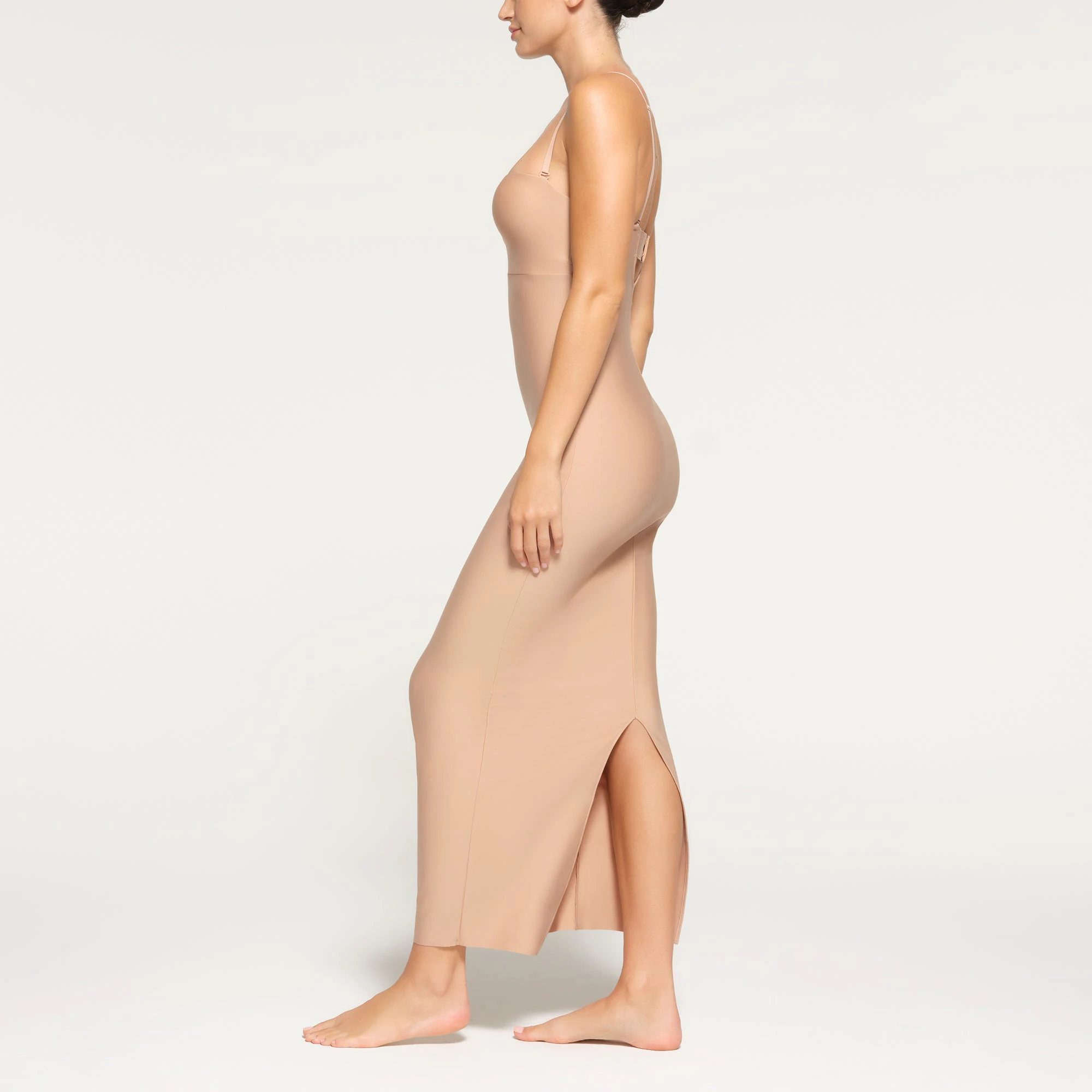 SKIMS BODY UNDERWIRE LONG DRESS WORN BY A MODEL IN SIDE VIEW