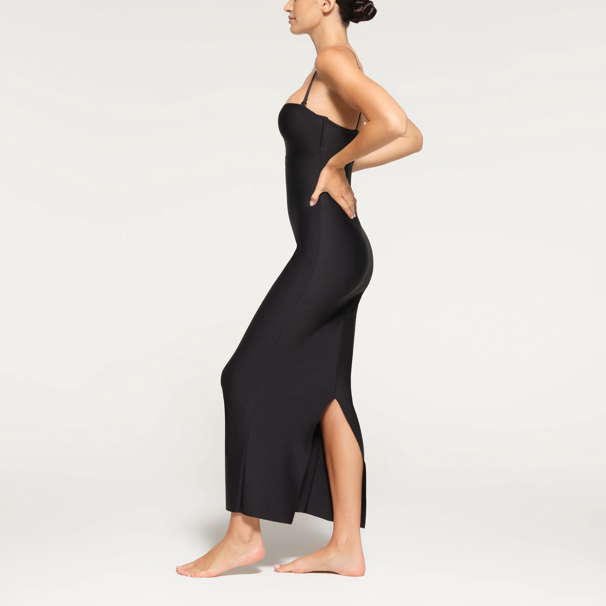 SKIMS BODY UNDERWIRE LONG DRESS WORN BY A MODEL IN SIDE VIEW