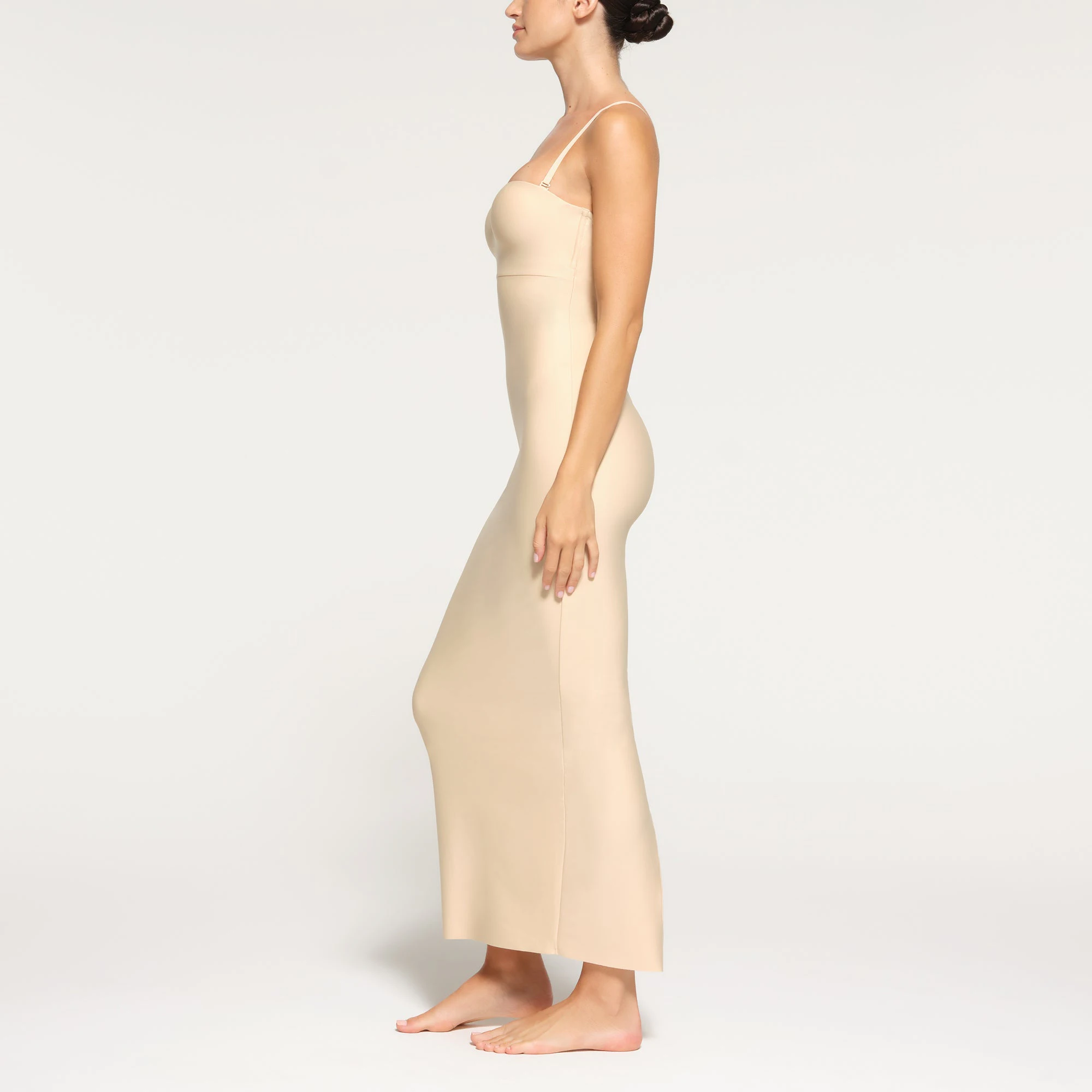SKIMS BODY UNDERWIRE LONG DRESS WORN BY A MODEL IN SIDE VIEW