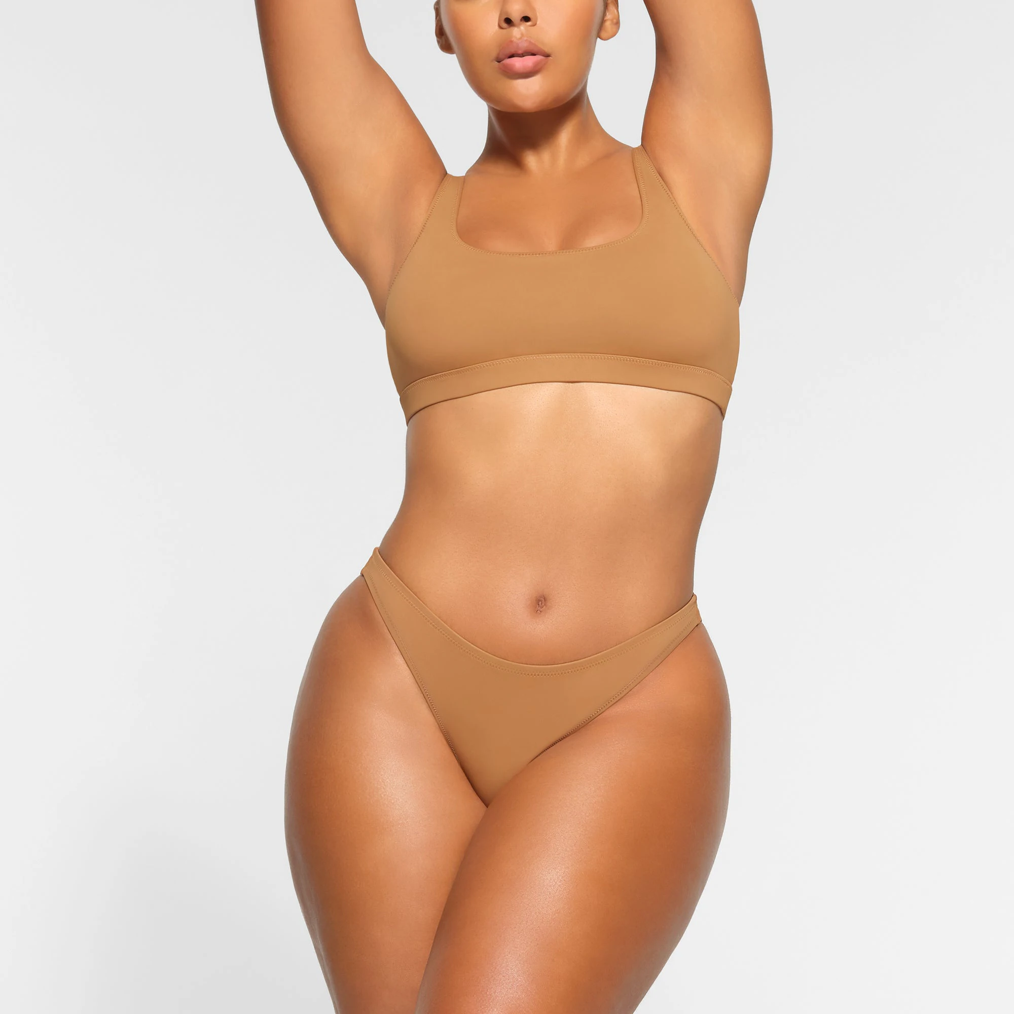 SWIM MID COVERAGE BOTTOMS WORN BY A MODEL IN FRONT VIEW