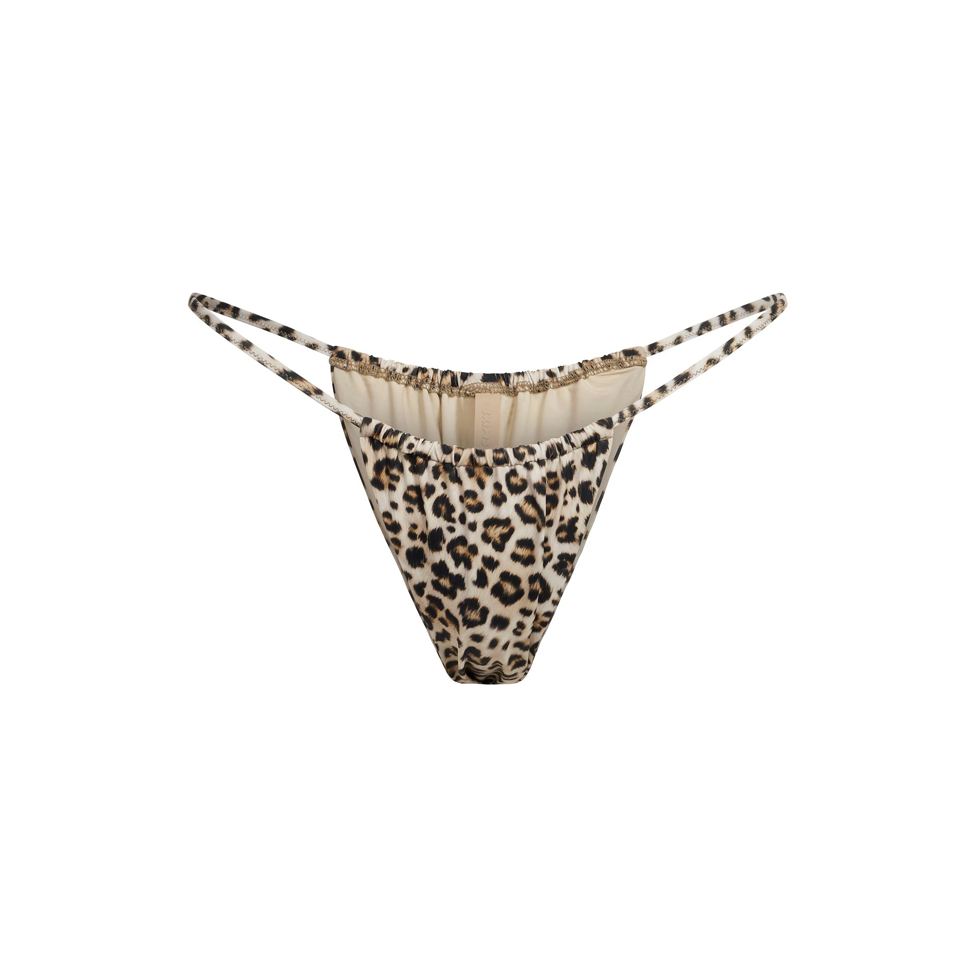 SIGNATURE SWIM STRING BIKINI BOTTOM | CHAMPAGNE LEOPARD PRINT FLAT ON A WHITE BACKGROUND | FLT