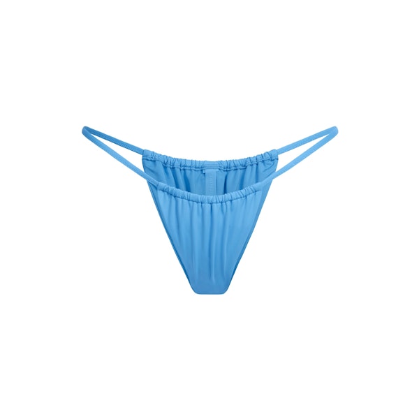 SIGNATURE SWIM STRING BIKINI BOTTOM | TIDE FLAT ON A WHITE BACKGROUND | FLT