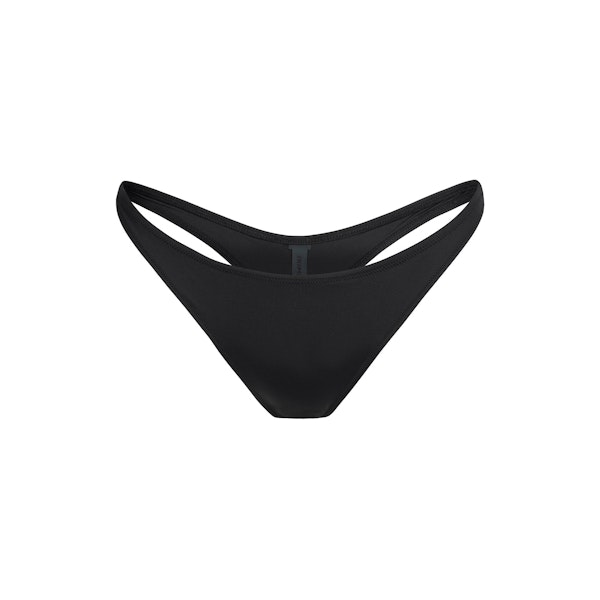 SIGNATURE SWIM THONG BIKINI BOTTOM | ONYX FLAT ON A WHITE BACKGROUND | FLT